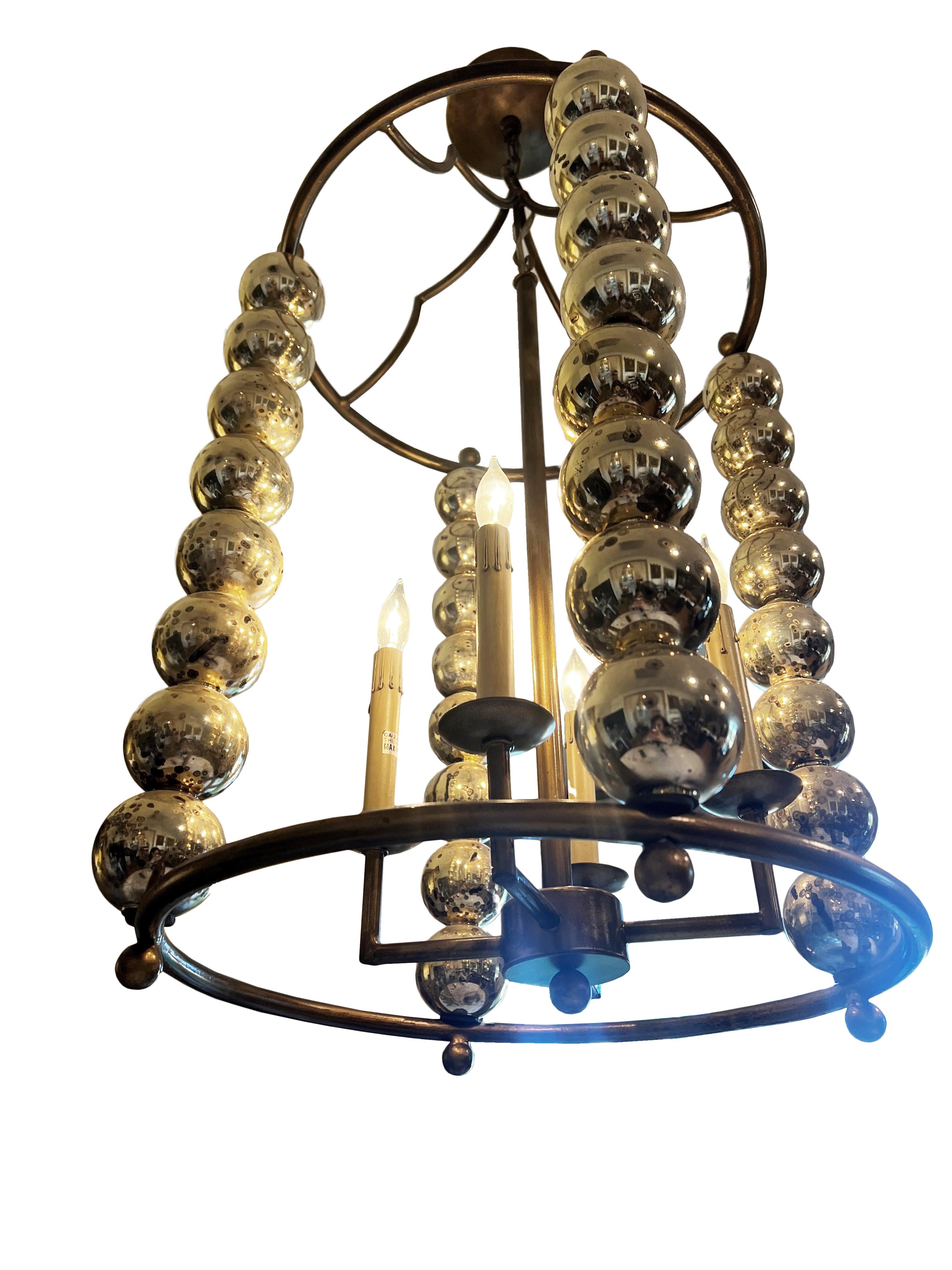 Introducing the Fiona Chandelier – a captivating blend of timeless elegance and versatility. This exquisite chandelier boasts an antique brass frame adorned with variegated gold balls, creating a visual symphony that adds a touch of opulence to any