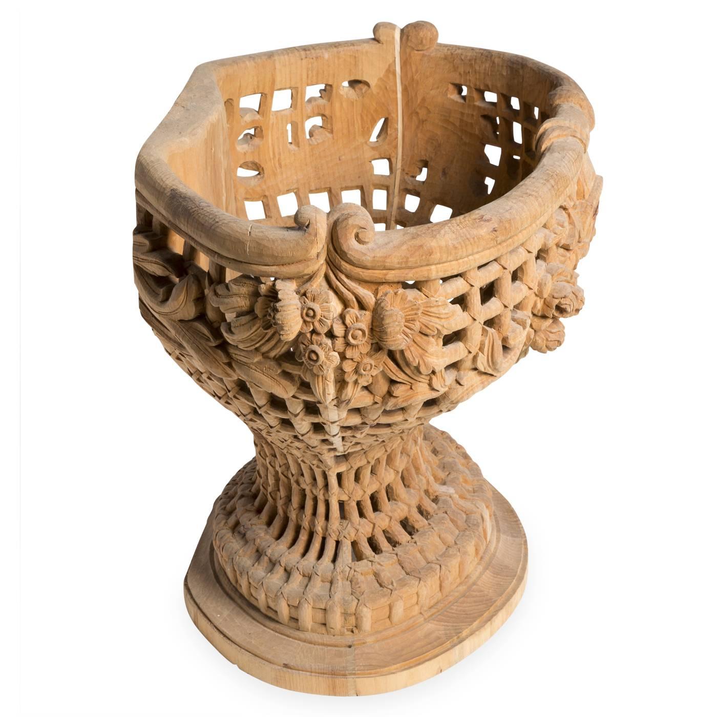 Ornamental flower basket by Bartolozzi e Maioli in Austrian pine. The handcrafted openwork form is decorated with floral features in high relief. The original piece was made in 1980 for a private residence in California.