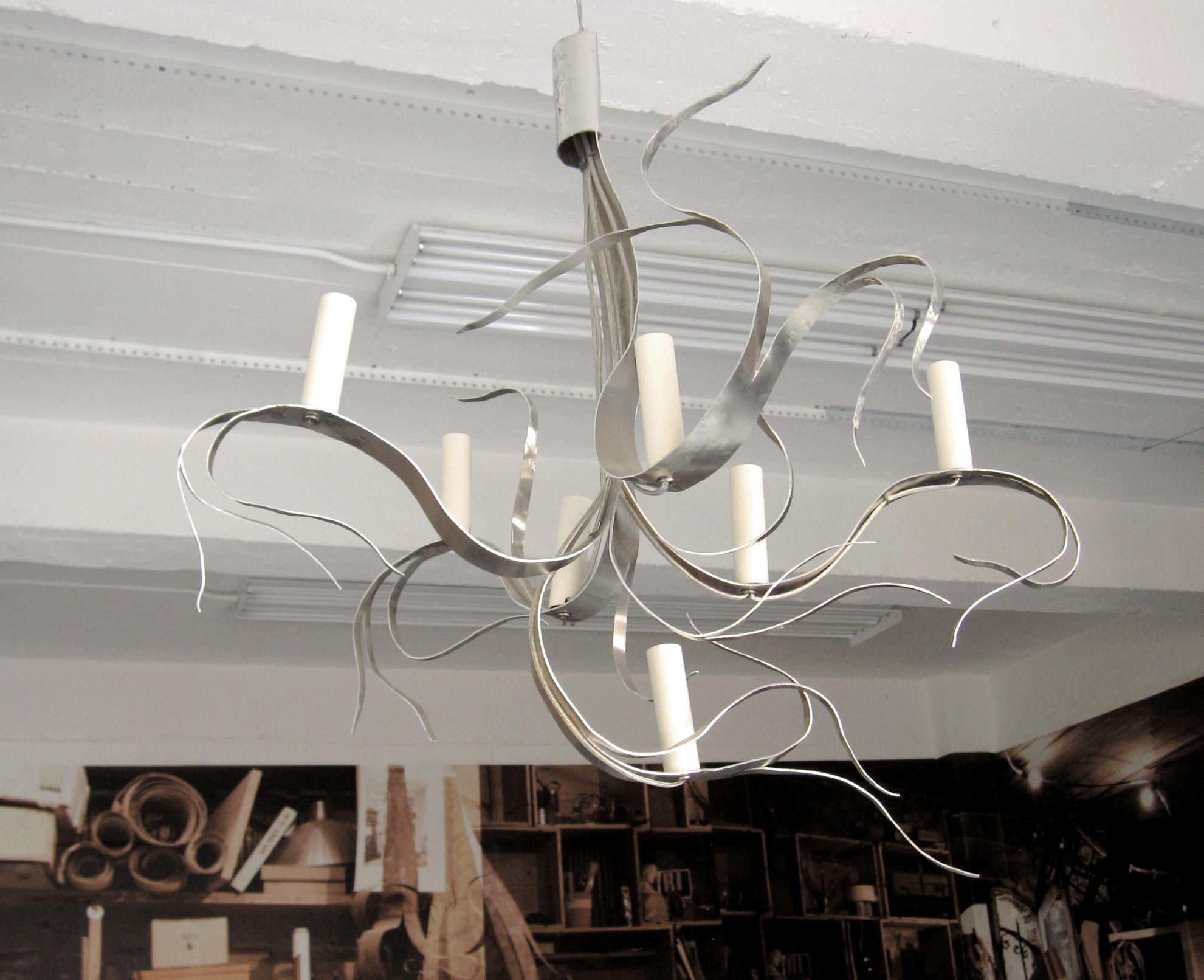 Inspired Karl Blossfeldt’s photographs of plants Jacques Jarrige cut from one sheet of aluminum without discarding any part this 7 light chandelier. Signed.
