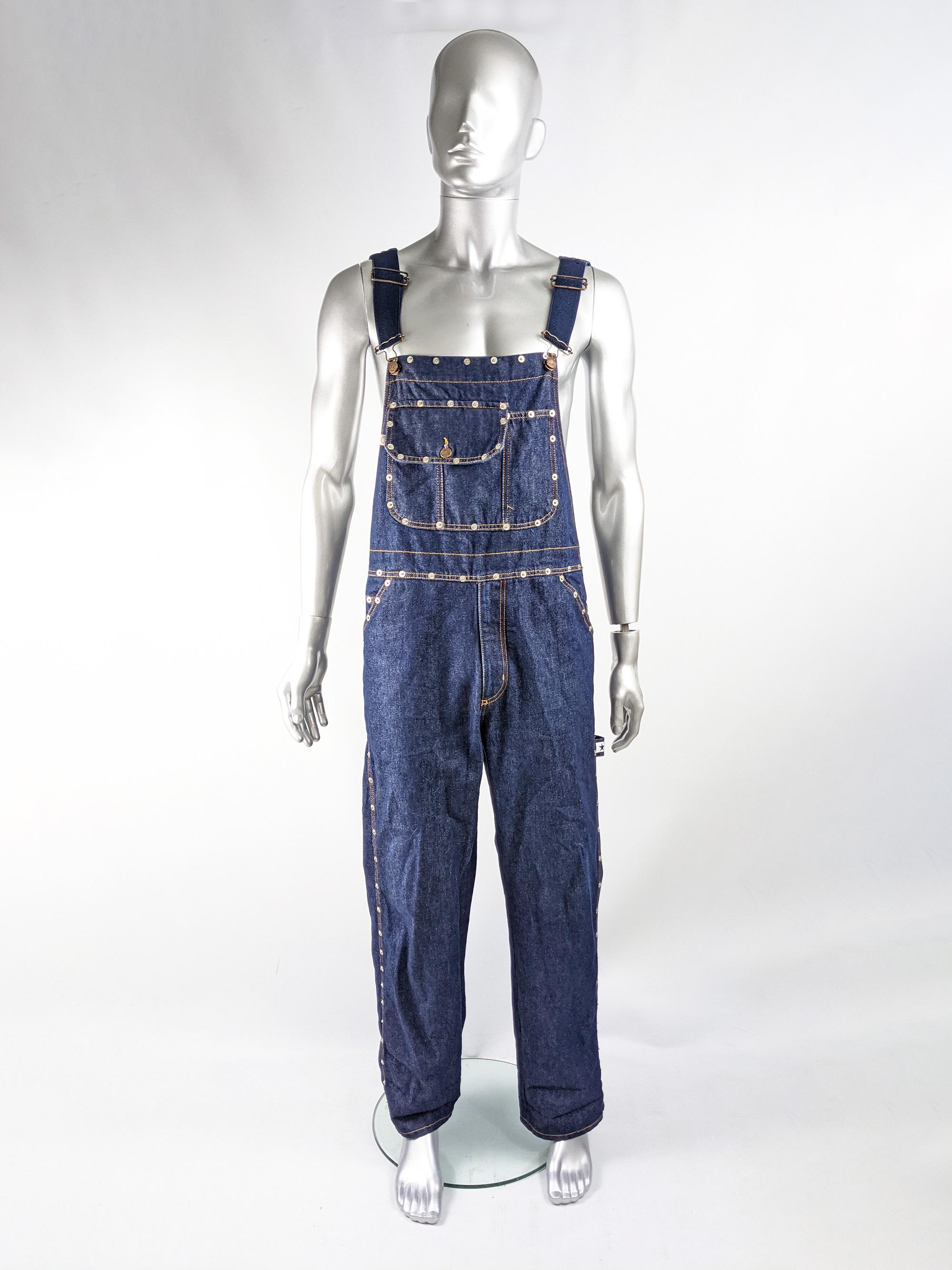 An amazing pair of vintage dungarees / overalls by luxury Italian label, Fiorucci. In a blue denim with stud details throughout, Fiorucci branding on the straps and studs, multiple pockets and dark blue knit straps. 

Size: Marked to fit 32” waist