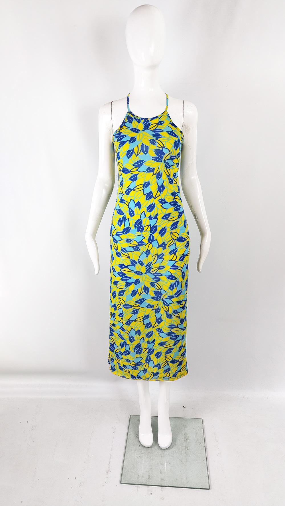 A fabulous and rare vintage womens dress from the 90s by luxury Italian fashion house, Fiorucci. In a lightweight crepe fabric with a beautifully vibrant yellow and blue leafy print. It has a halter neck that ties around the back of the neck above a
