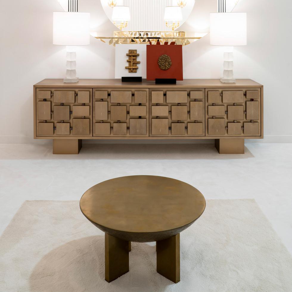 A sculptural design of utmost sophistication, this coffee table will make for a stately and unique accent piece in a living area of both private and contract interiors. Handmade of wood, it is covered with liquid metal and finished with a bronzed