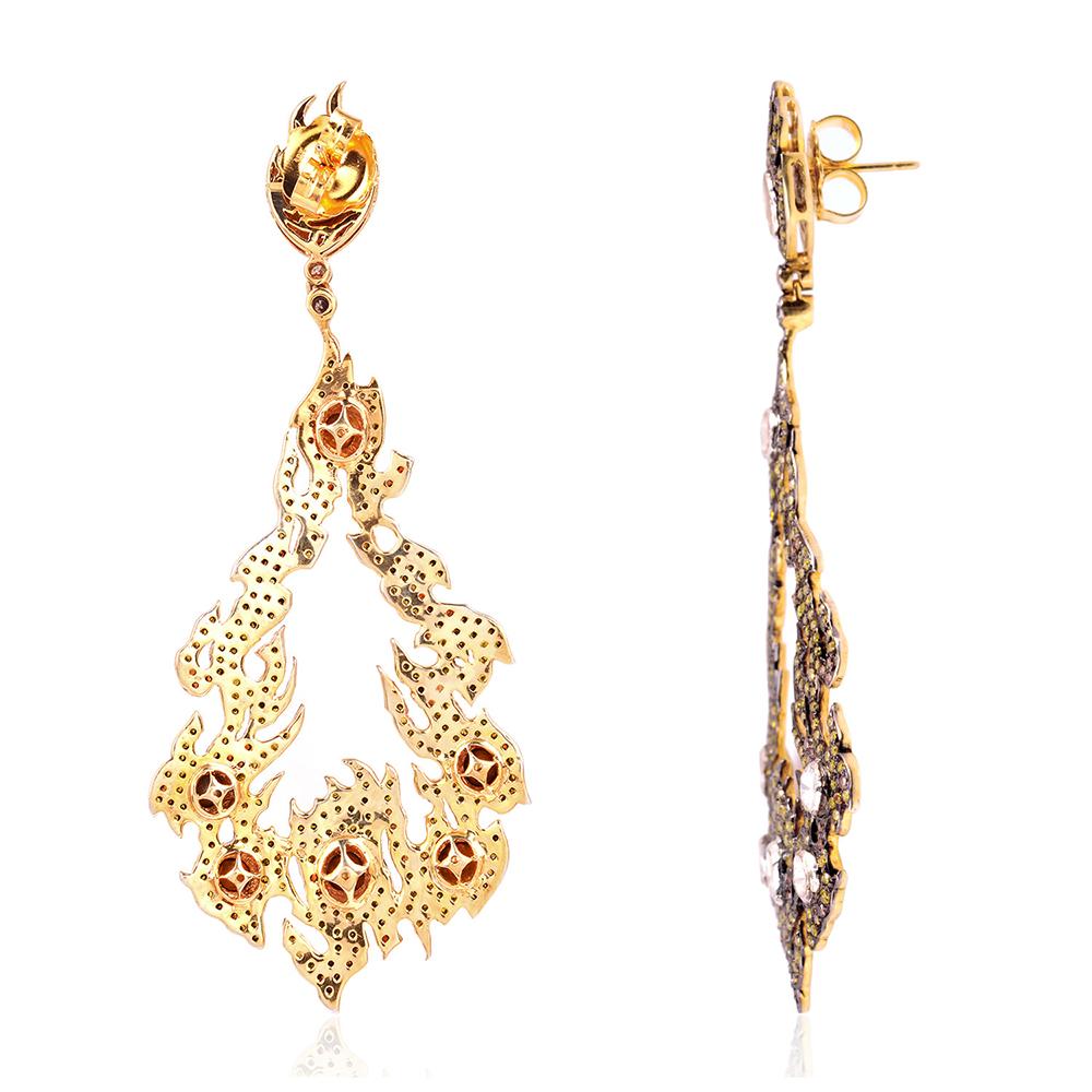 Get ready to put the fire on with these flame designed earring which is set with pave yellow sapphire and rose cut diamonds around.

Closure: Push Post

18kt: 1.9gms
Diamond: 7.06Cts
Slv: 17.008gms
