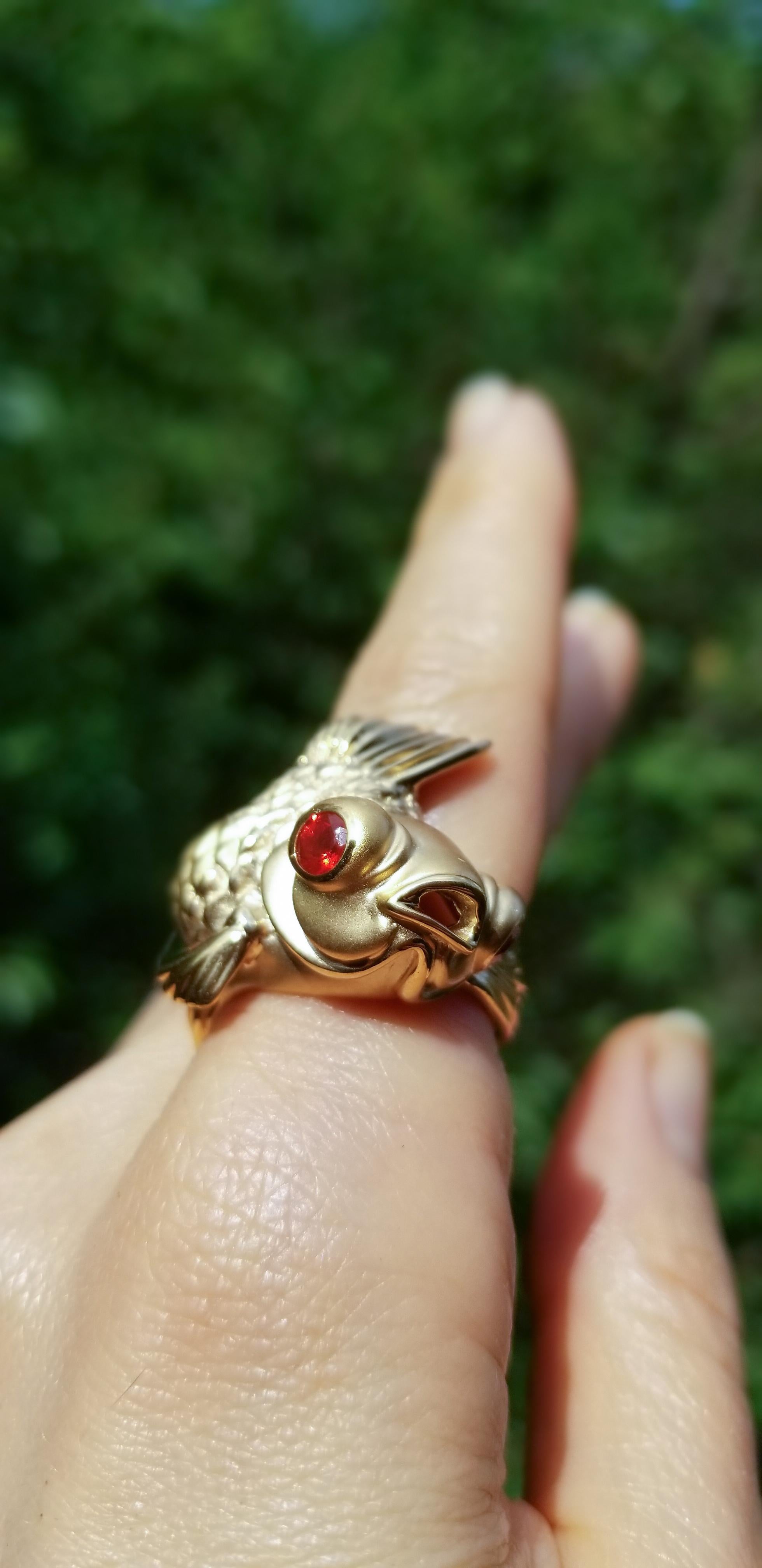 A symbol of good luck, good fortune, and fortitude, this Goldfish swims by on the wearer's hand, his gold body glistening and his fire opal eyes sparkling.
His sinuous body wraps gracefully around a single finger, comfortably close to the