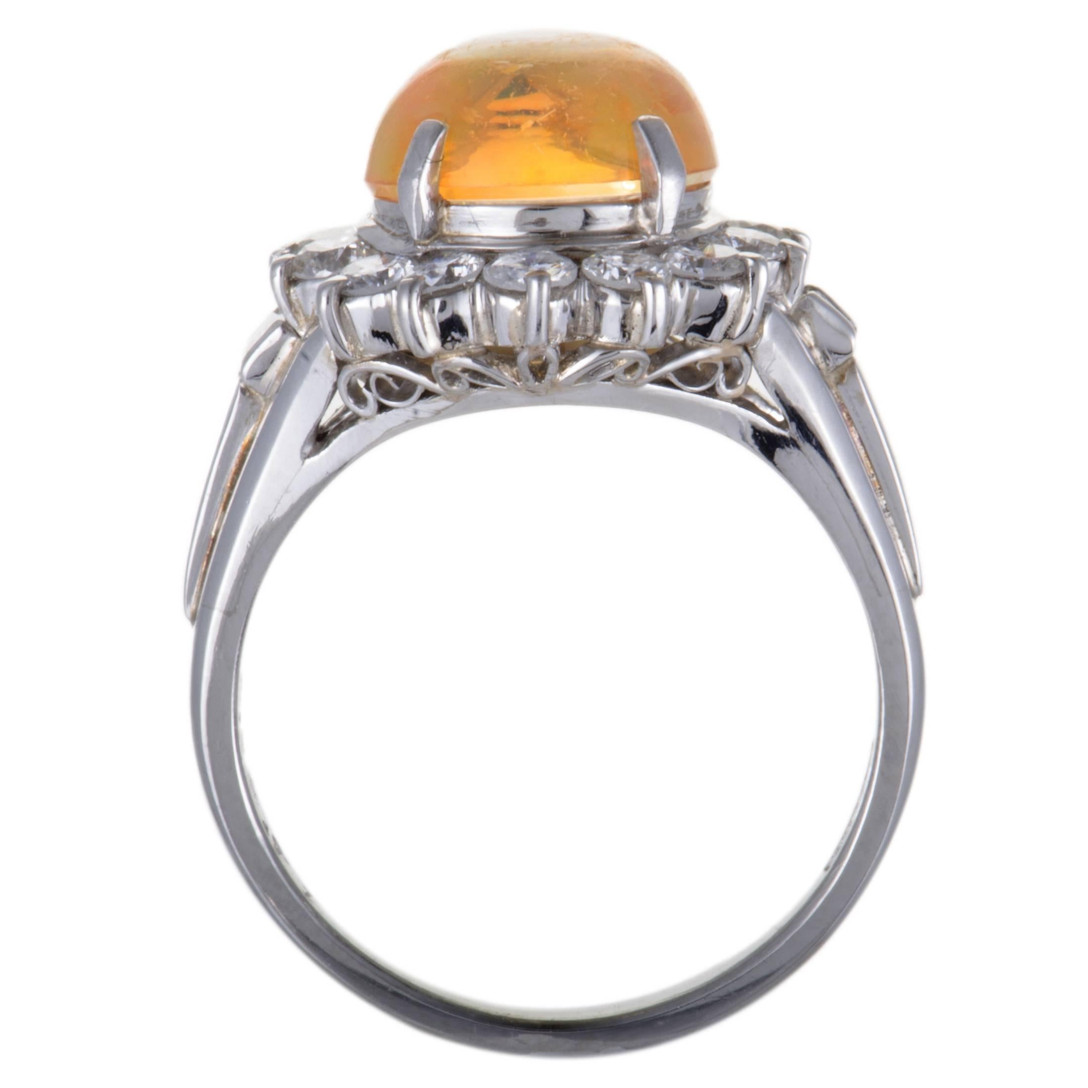 The fashionable design of this splendid ring boasts a nifty feel of prestigious elegance. The fascinating ring is made of shimmering platinum and beautifully decorated with 0.71ct of sparkling diamonds and a magnificent fire opal weighing
