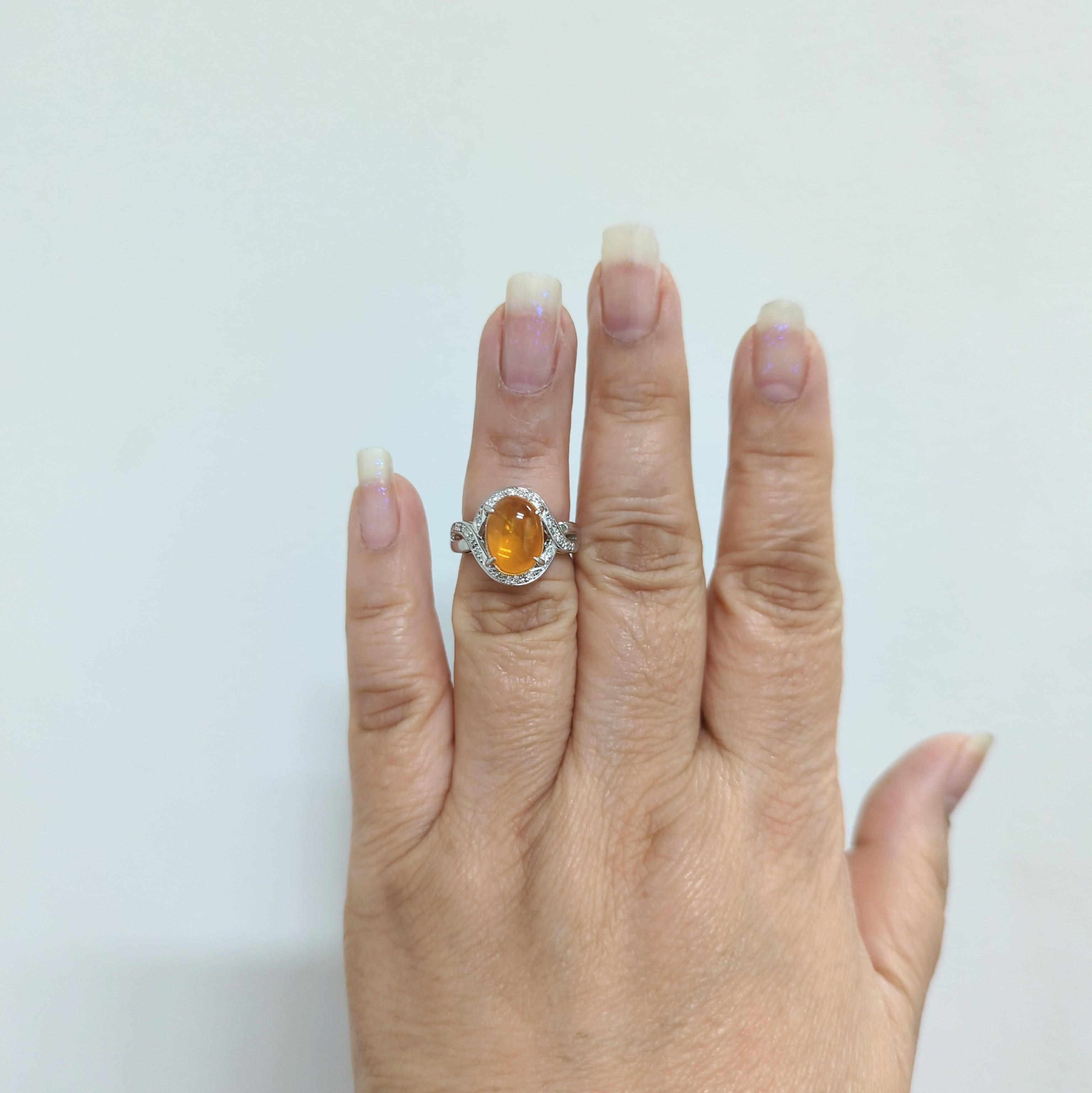 Beautiful 2.95 ct. fire opal oval cabochon with 0.14 ct. good quality white diamond rounds.  Handmade in platinum.  Ring size 5.75.