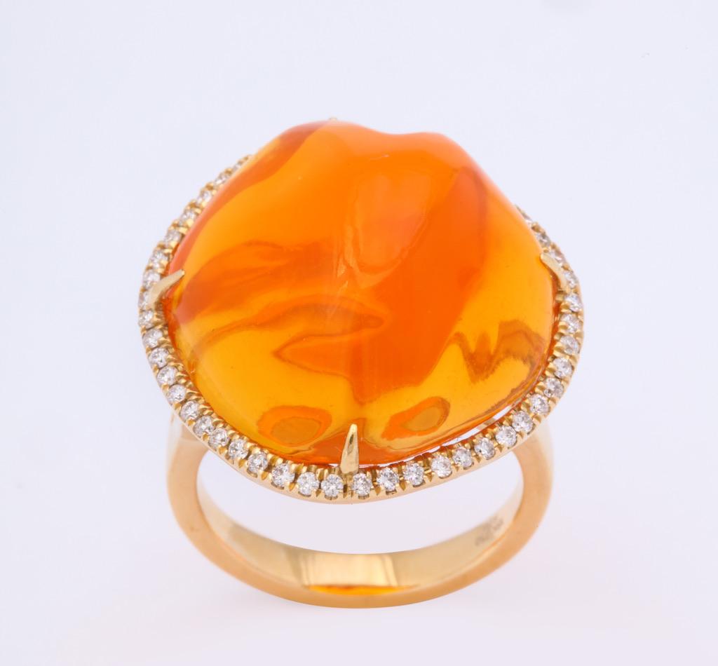 18kt yellow gold featuring a baroque cut Mexican fire opal and further embellished with round diamonds.