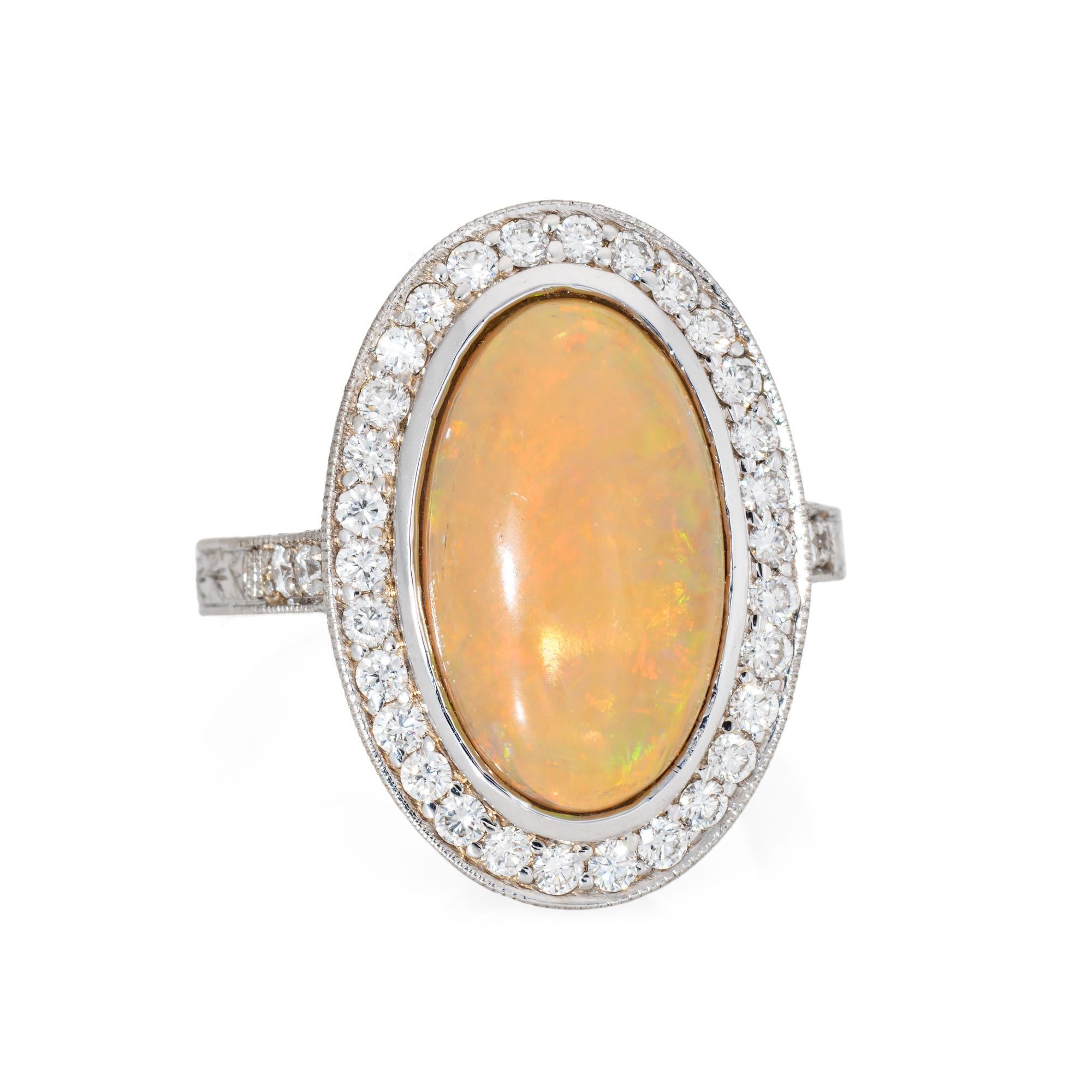Stylish natural Ethiopian fire opal & diamond ring crafted in 18k white gold. 

Natural opal measures 16mm x 11mm (estimated at 7.50 carats). The diamonds total an estimated 0.35 carats (estimated at H-I color and VS2-SI2 clarity). The opal is in