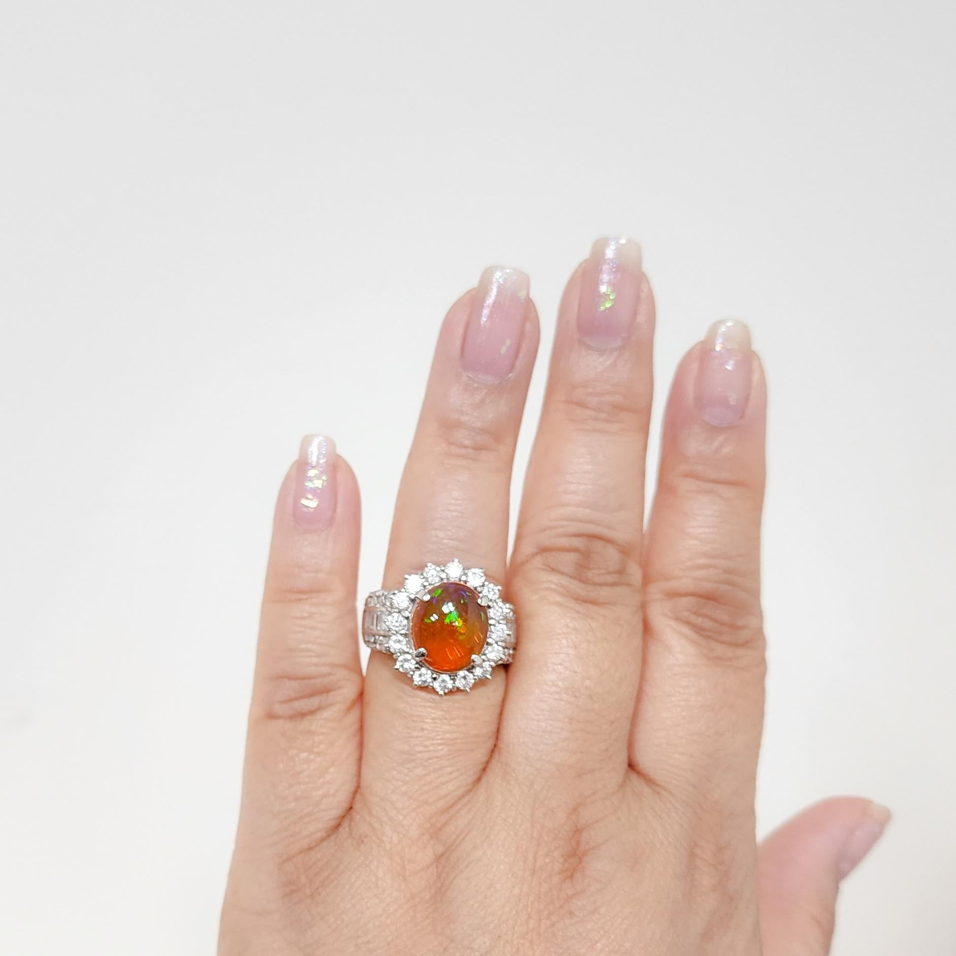 Gorgeous 4.27 ct. fire opal oval cabochon with 2.40 ct. white diamond rounds and baguettes.  Handmade in platinum.  Ring size 9.