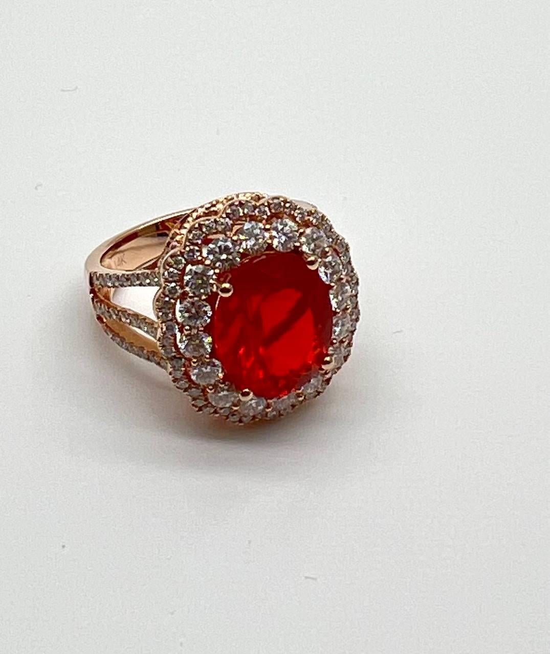 Elegancia y Sofisticación Radiantes. Engastada con una gema de ópalo de fuego ovalado rojo fuego de 4,06 quilates. Rodeada de brillantes diamantes redondos de 1,57 qt. Fabricada en oro rosa de 14 quilates.