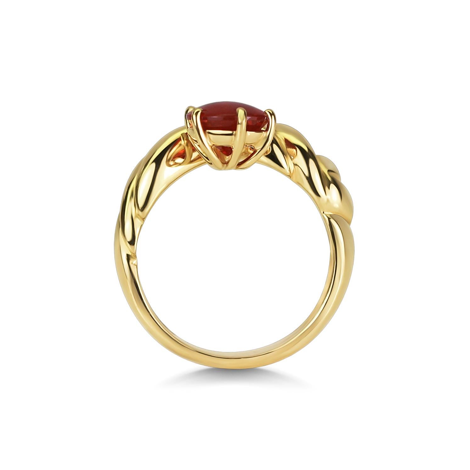 Uniquely cut 'Paisley' tear drop shaped Fire Opal held in a wire-work setting, nestled in a carved 18ct yellow gold band. 

This Fire Opal is a beautiful example of this type of gem stone. The colour quality and luster are extremely eye catching.