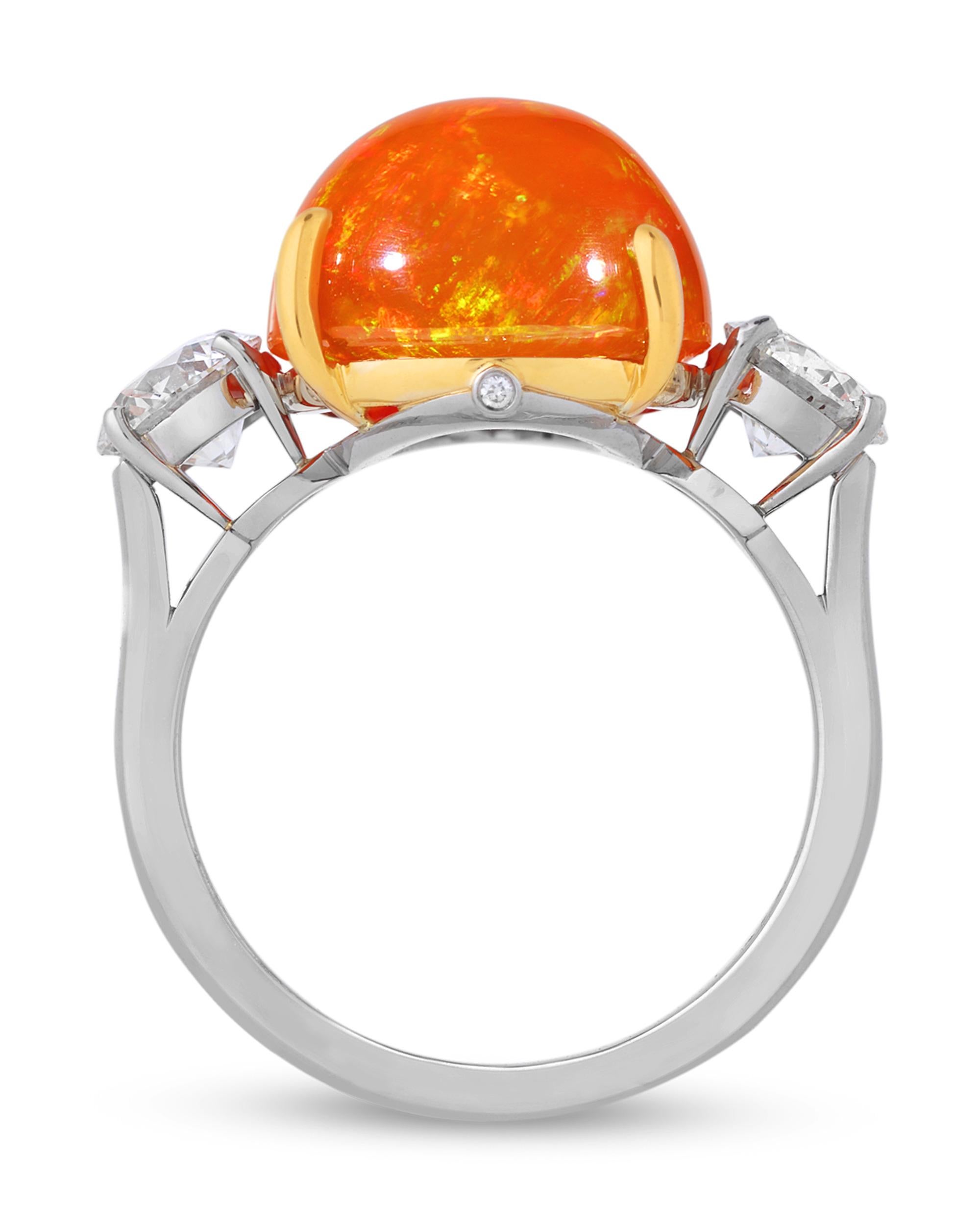 A stunning display of one of the most coveted marvels of nature, this ring by Oscar Heyman centers an exquisite vivid Mexican fire opal. The incredible 7.79-carat cabochon gem is certified by the Deutsche Stiftung Edelsteinforschung (DSEF) German