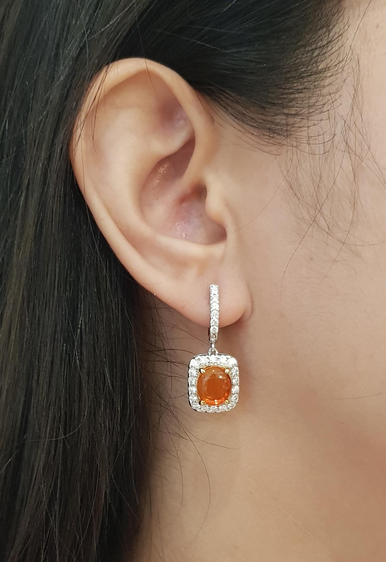 Fire Opal 3.30 carats with Diamond 1.17 carats Earrings set in 18K White Gold Settings

Width: 1.2 cm 
Length: 3.0 cm
Total Weight: 8.14 grams

