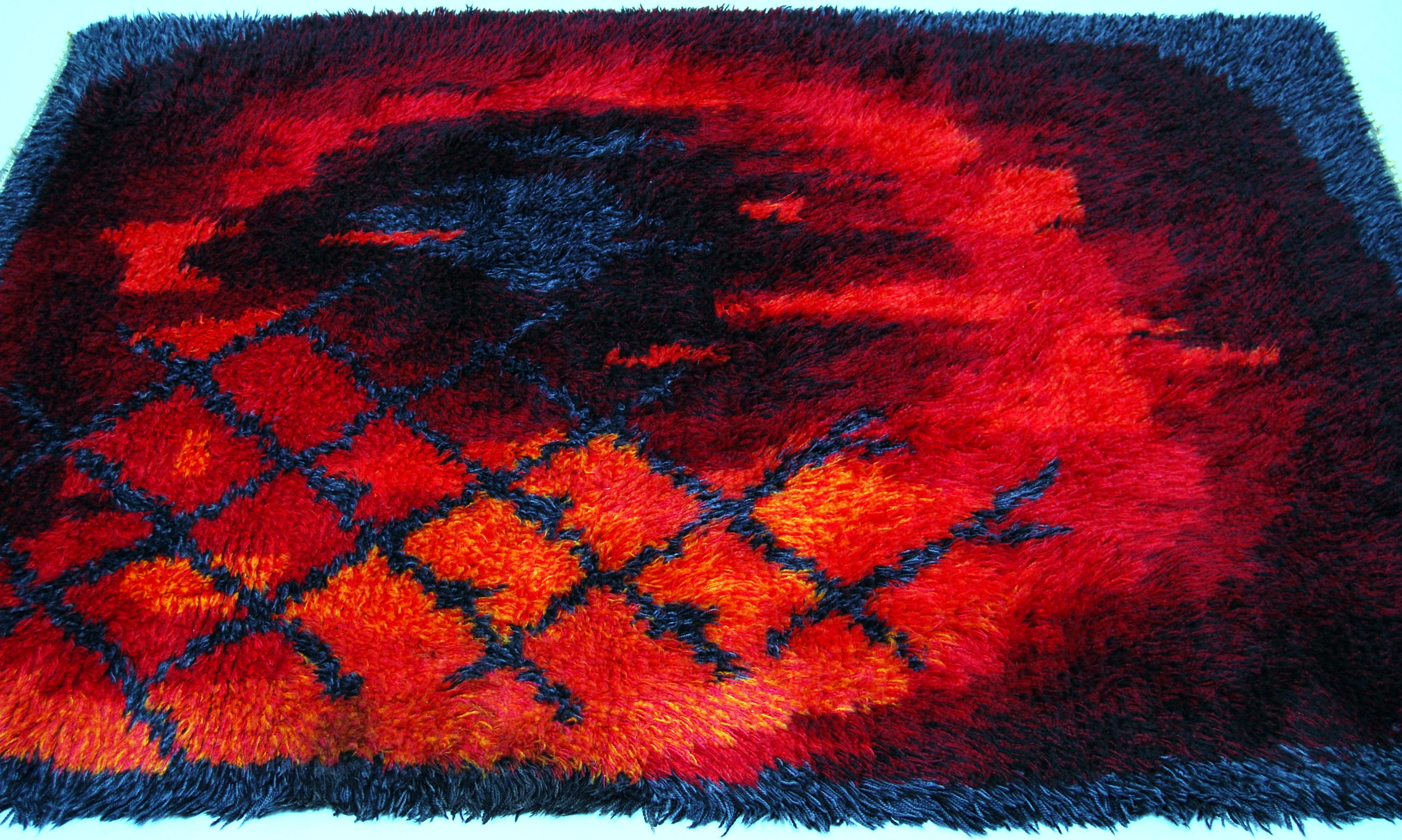 Danish Rya rug / carpet by Ege Rya with a great abstract, fire pattern design in various shades of red, orange, purple, yellow and blue. Suitable as a carpet or as a wall-hung work of art. Professionally water cleaned.

 