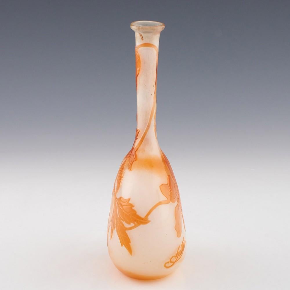 Heading : Gallé banjo vase
Date : c1905
Origin : Nancy, France
Bowl Features : Banjo form with orange clematis cameo.
Marks : *Gallé signature. The presence of the star gives this a date of 1904-1906
Type : Cameo glass
Size : 17.1cm height, 8.3cm at