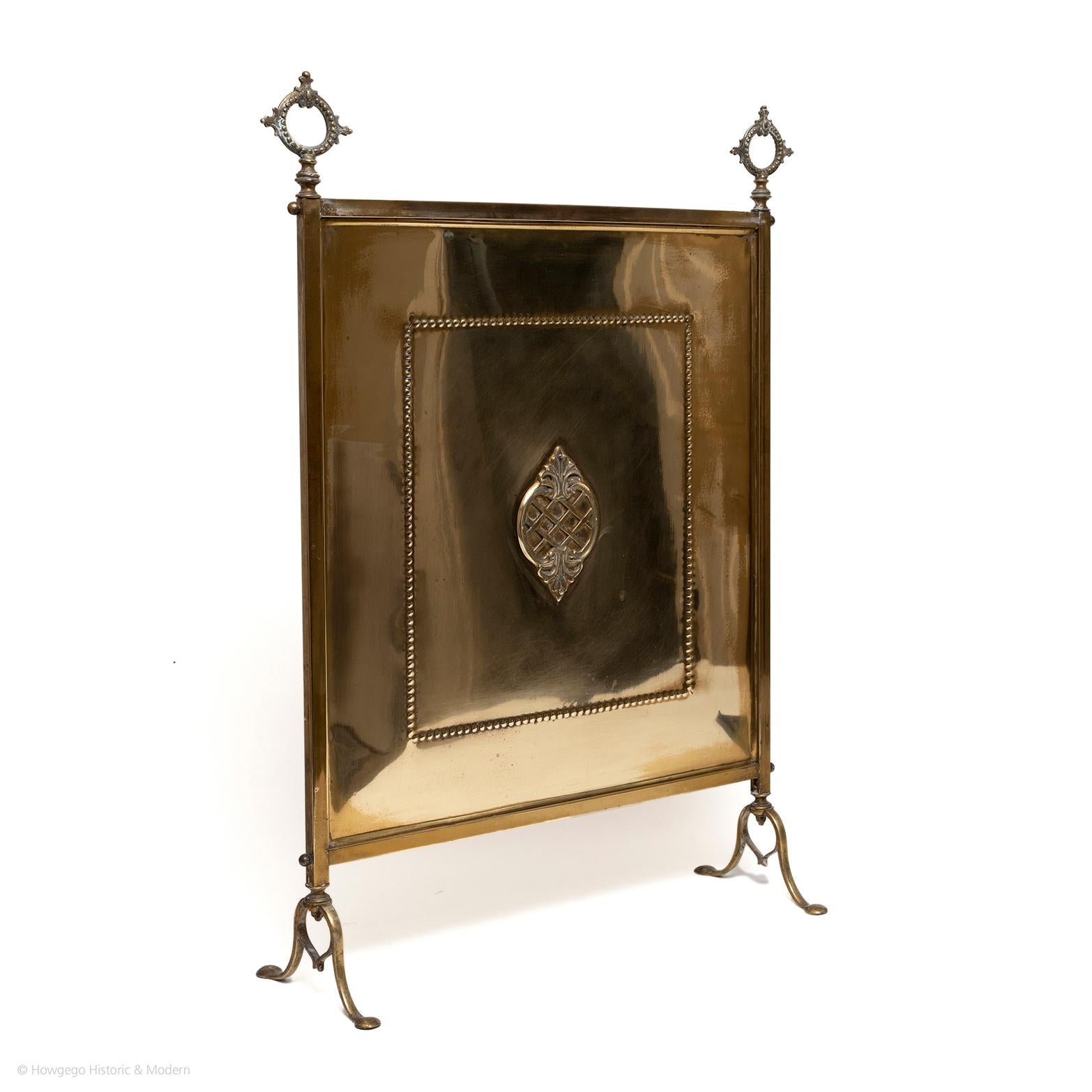 Attractive classical ornamentation creating relief and depth.
The heart motif is a charming feature
The brass amplifies the heat and reflects the light in the room

Two elaborate, decorative brass finials acting as carrying handles. Decorated