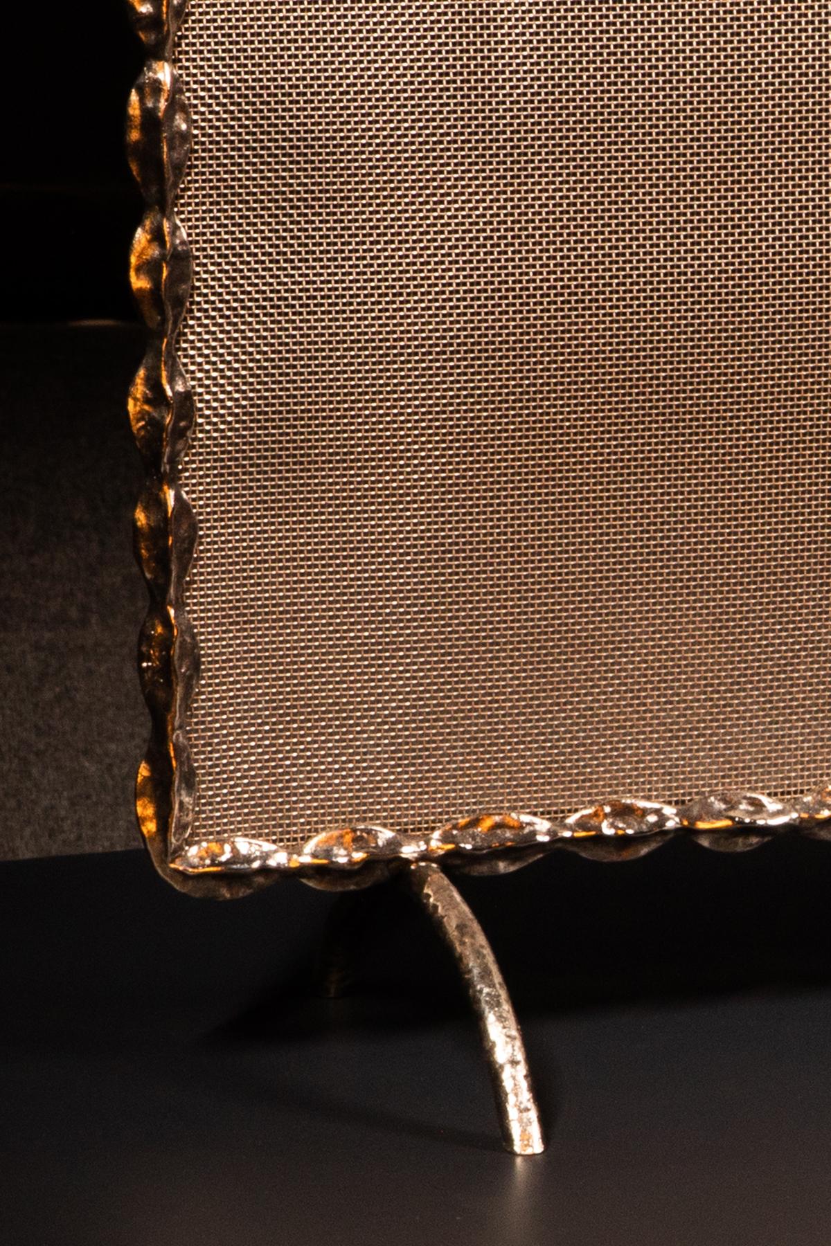 Rectangular silvered bronze frame with a repeating drop-like form, enclosing a steel mesh screen.

   