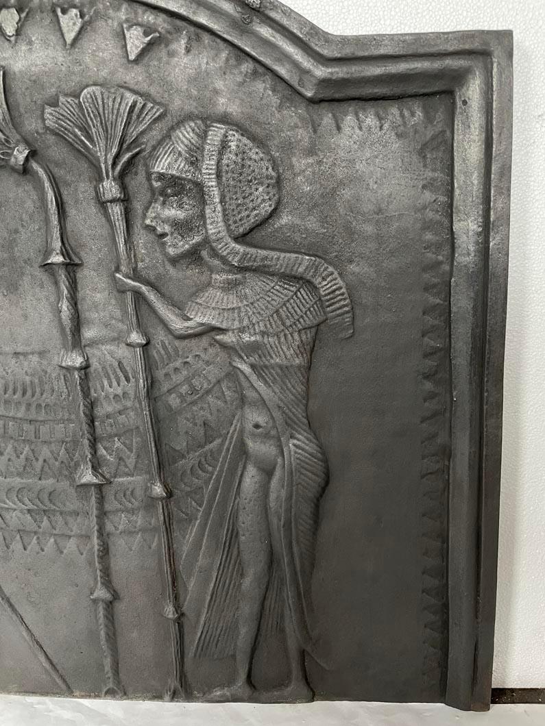 Cast Fireback Adorned with an Egyptian-Inspired Low-Relief For Sale