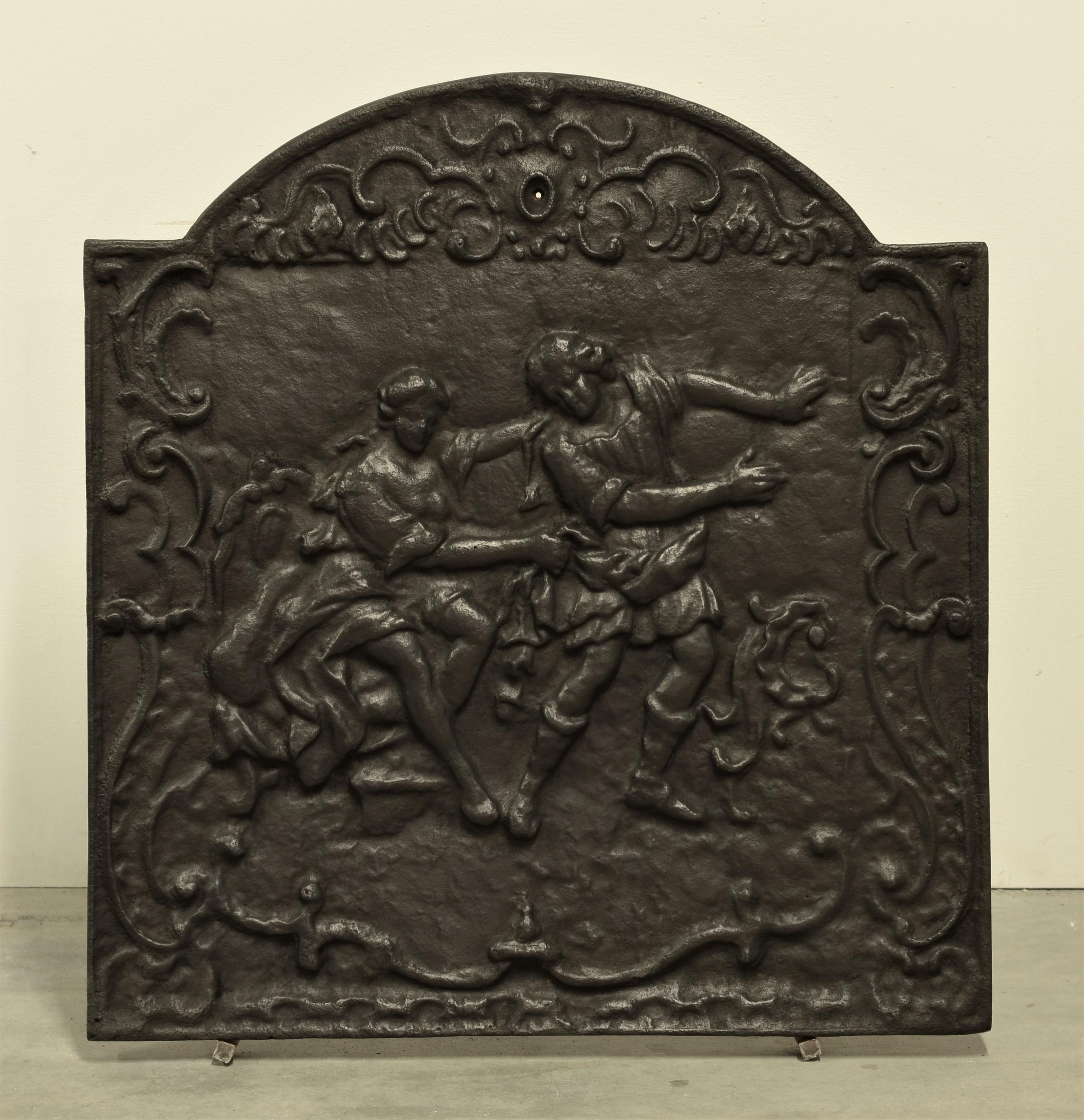 Fireback or backsplash displaying “The Art of Seduction”

Great detailed fireback from the 19th century.
It shows a sparse clothes male and female figure. The male appears to leave while being hold back with a cloth around his waist.

This