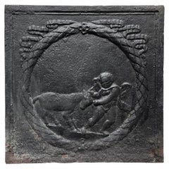 Plaque de cheminée du 18e siècle représentant un amour jouant avec une chèvre