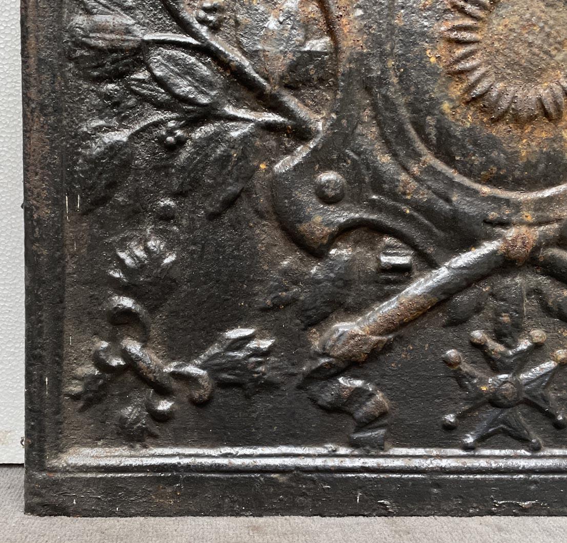 Cast Fireback from the 19th Century with a Shield Decorated with a Sunflower For Sale