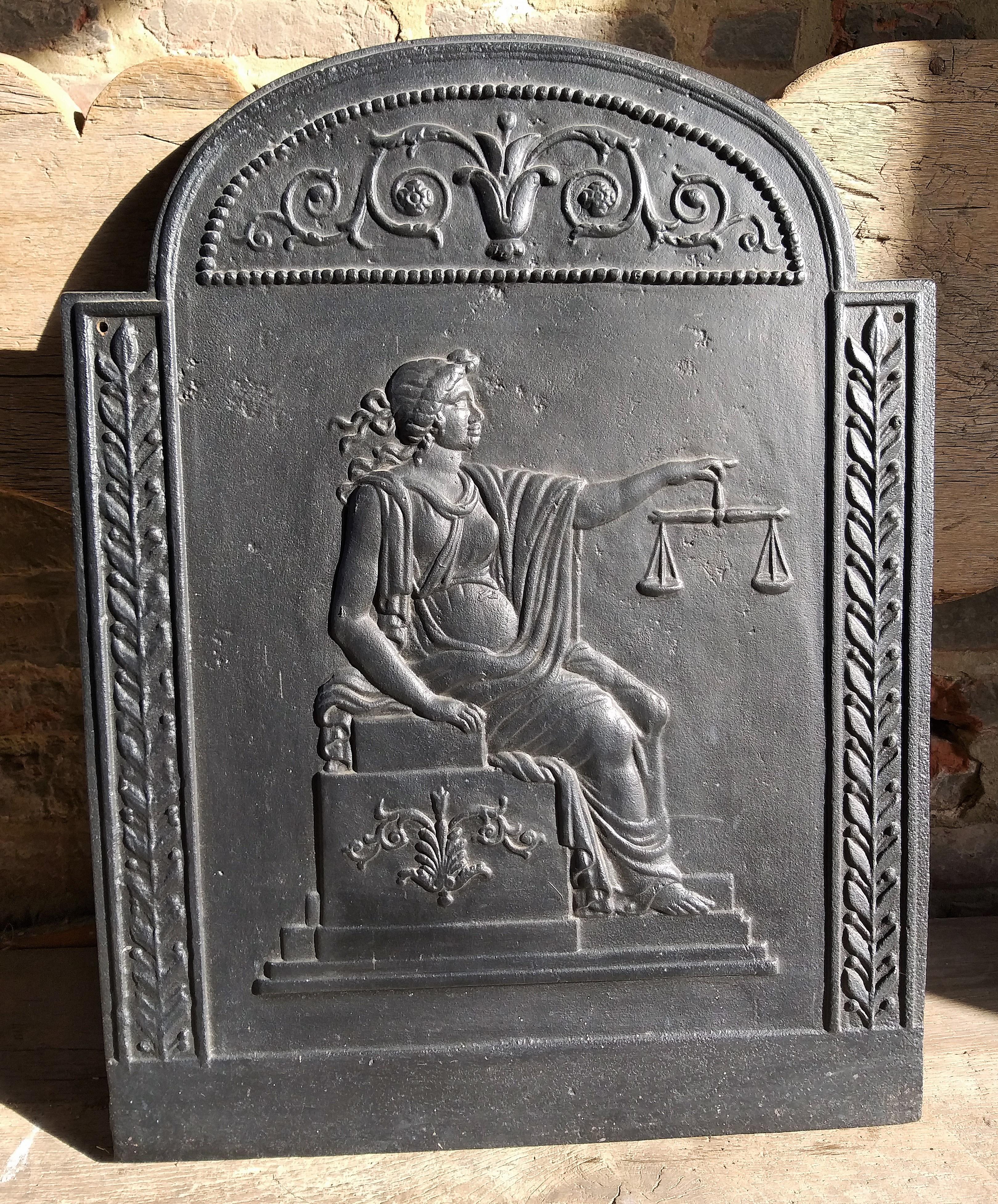 Fireback or backsplash in very good condition that dates back to early nineteenth century.
It shows Lady Justice, it originates from the ancient Roman. She is an Allegorical personification
of the moral force in judicial systems. The symbols are