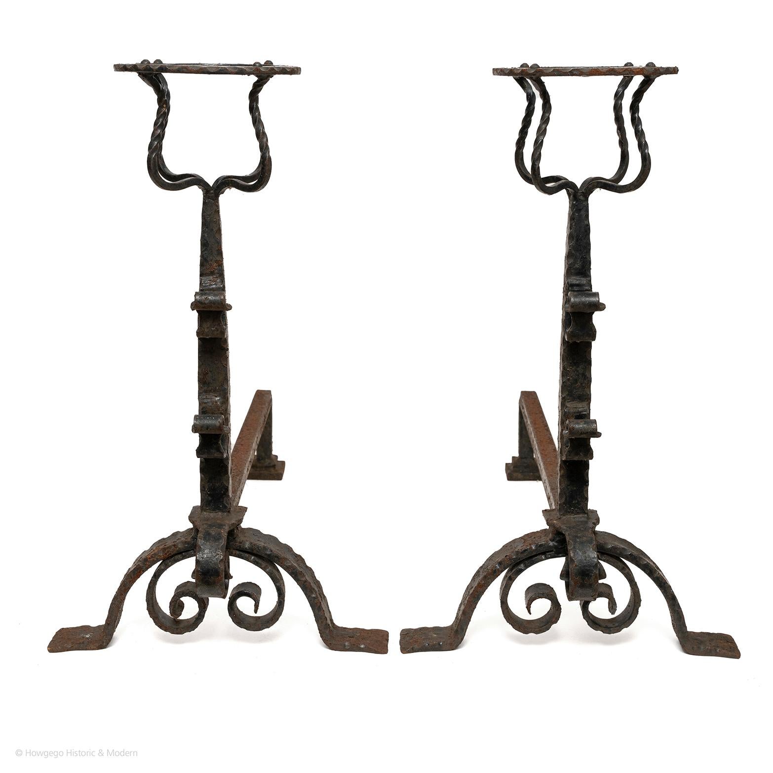 Elegant pair of Baroque wrought iron firedogs with mulling cups and spit racks for keeping food and liquids warm
Exhibit gravitas, made for a large inglenook fireplace
High quality with fine detailing - rippling, twisted and scroll work - suggesting