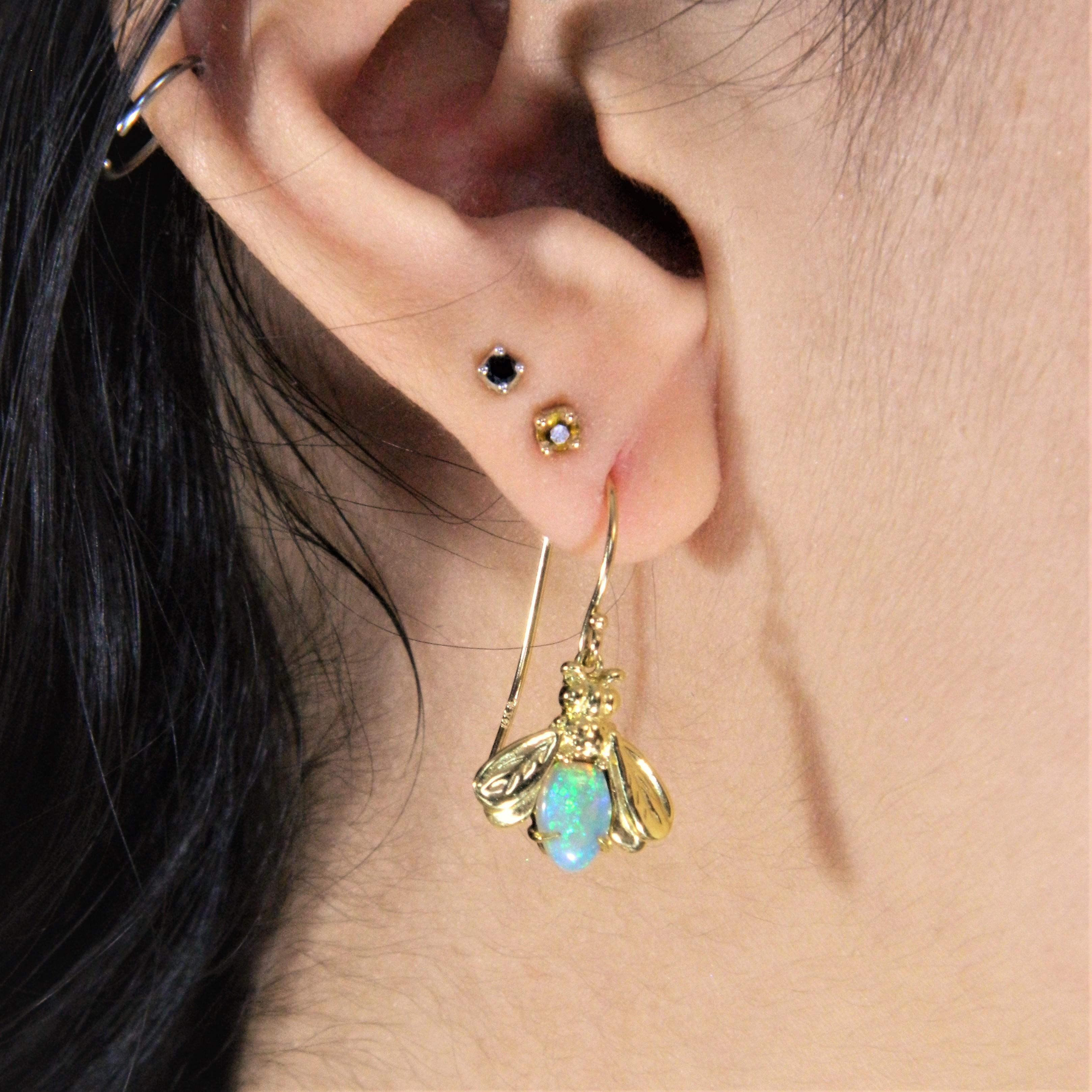 Custom cut Australian Lightning Ridge Opal tails of Firefly dangle earring in 18K Green gold. Each pair is a one of a kind due to variance in opal material. The opal is cut and polished in Canada and the firefly jewelry work in NYC. 
The