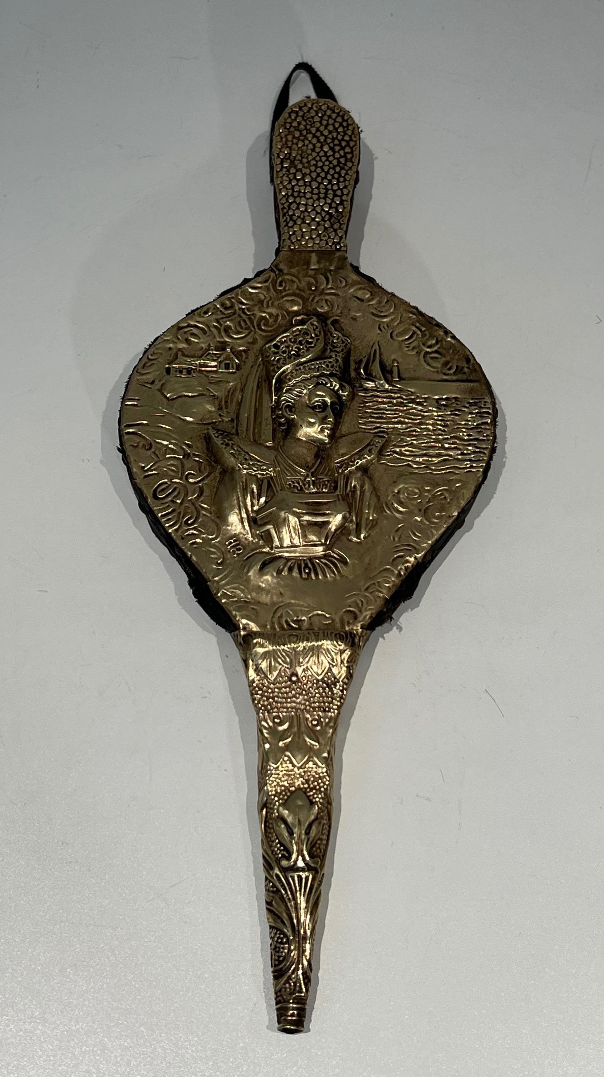 This rare fireplace bellows is made of embossed brass on wood; The embossed brass represents a woman. This is a French work in Louis the 16th style. Circa 1900