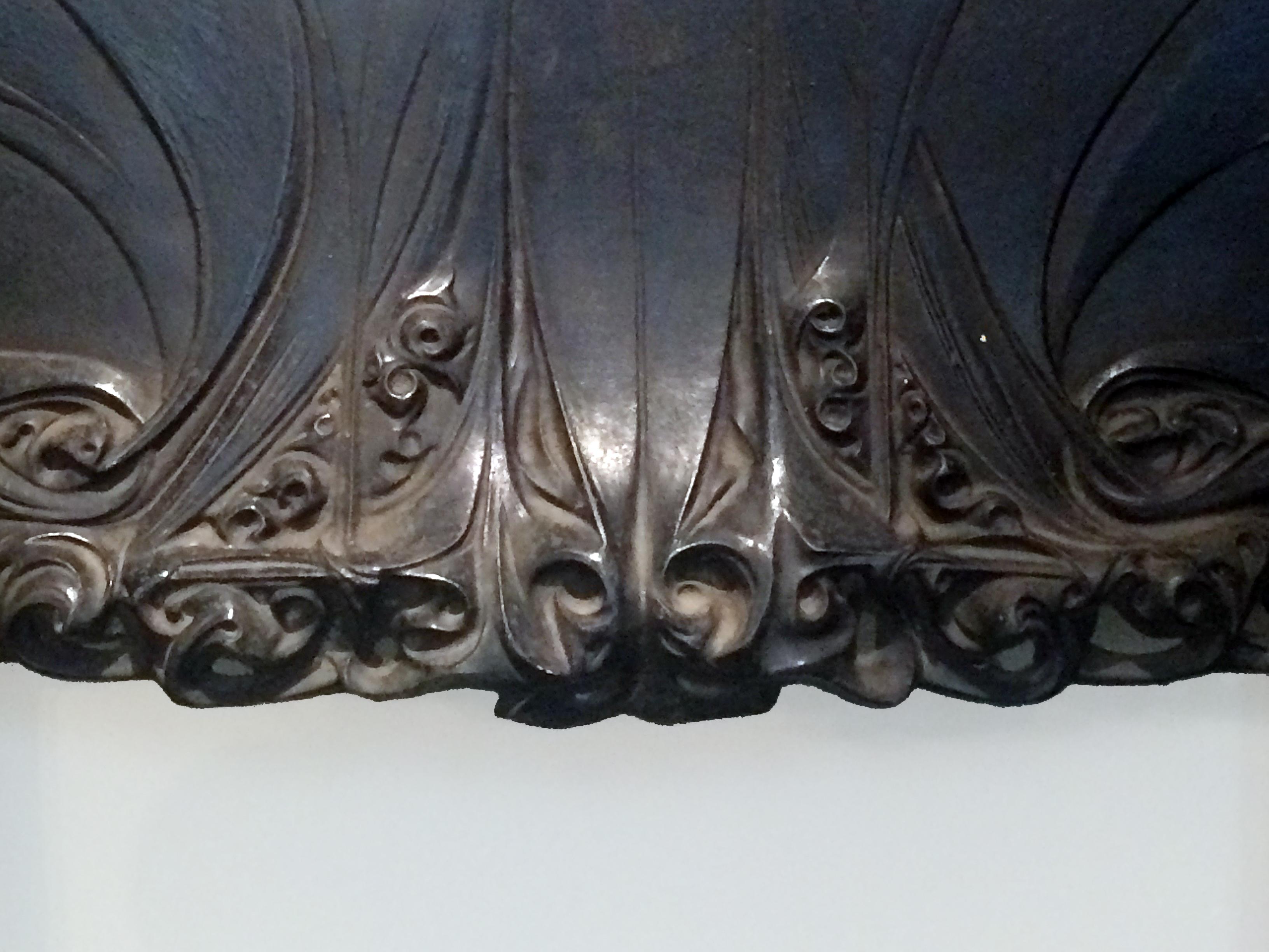 Black patina cast iron fireplace interior.
The side posts are ornamented with scrolls at the base.
The pediment is richly carved in low relief with tendrils and scrolls forming cuts and reliefs.
Bibliography : Album des Fonderies de Saint Dizier,