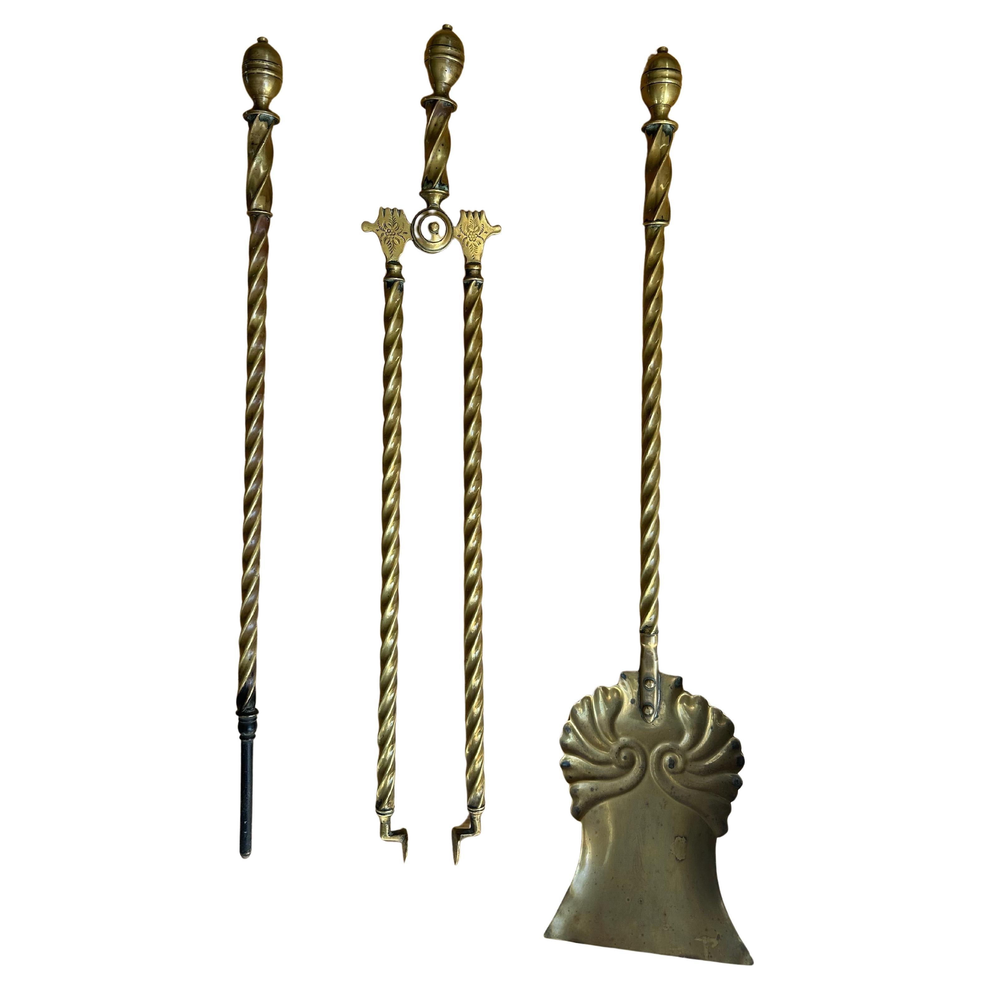 This 19th-century fireplace companion set is a charming and functional addition to any hearth. The set includes essential tools such as a poker, tongs, shovel, and brush, all crafted with fine attention to detail and designed for both utility and
