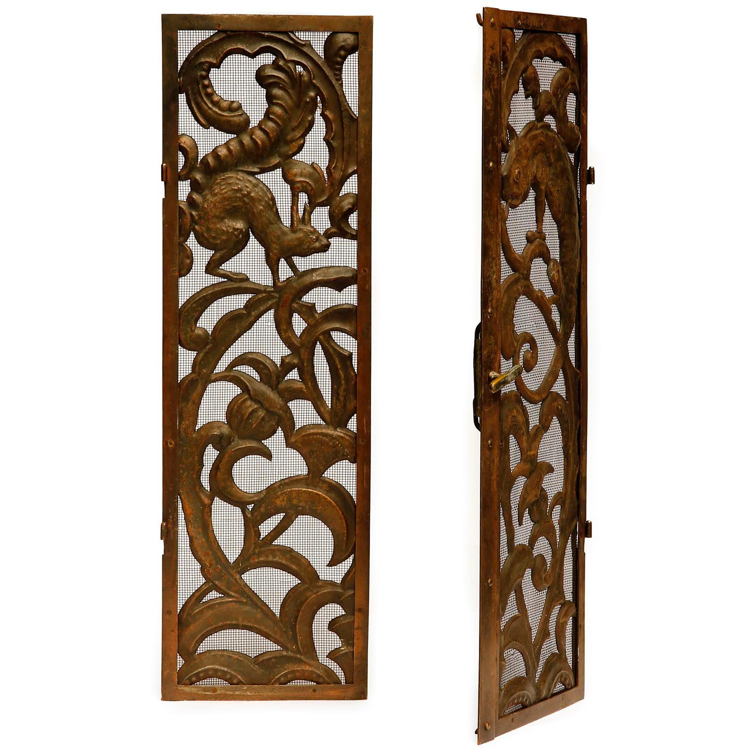 An antique and gorgeous pair of fireplace doors manufactured in Austria, circa 1900.
The doors are made of a thin metal grid which are decorated with floral and figural ornaments and animals of hammered and patinated metal, brass or copper.
The