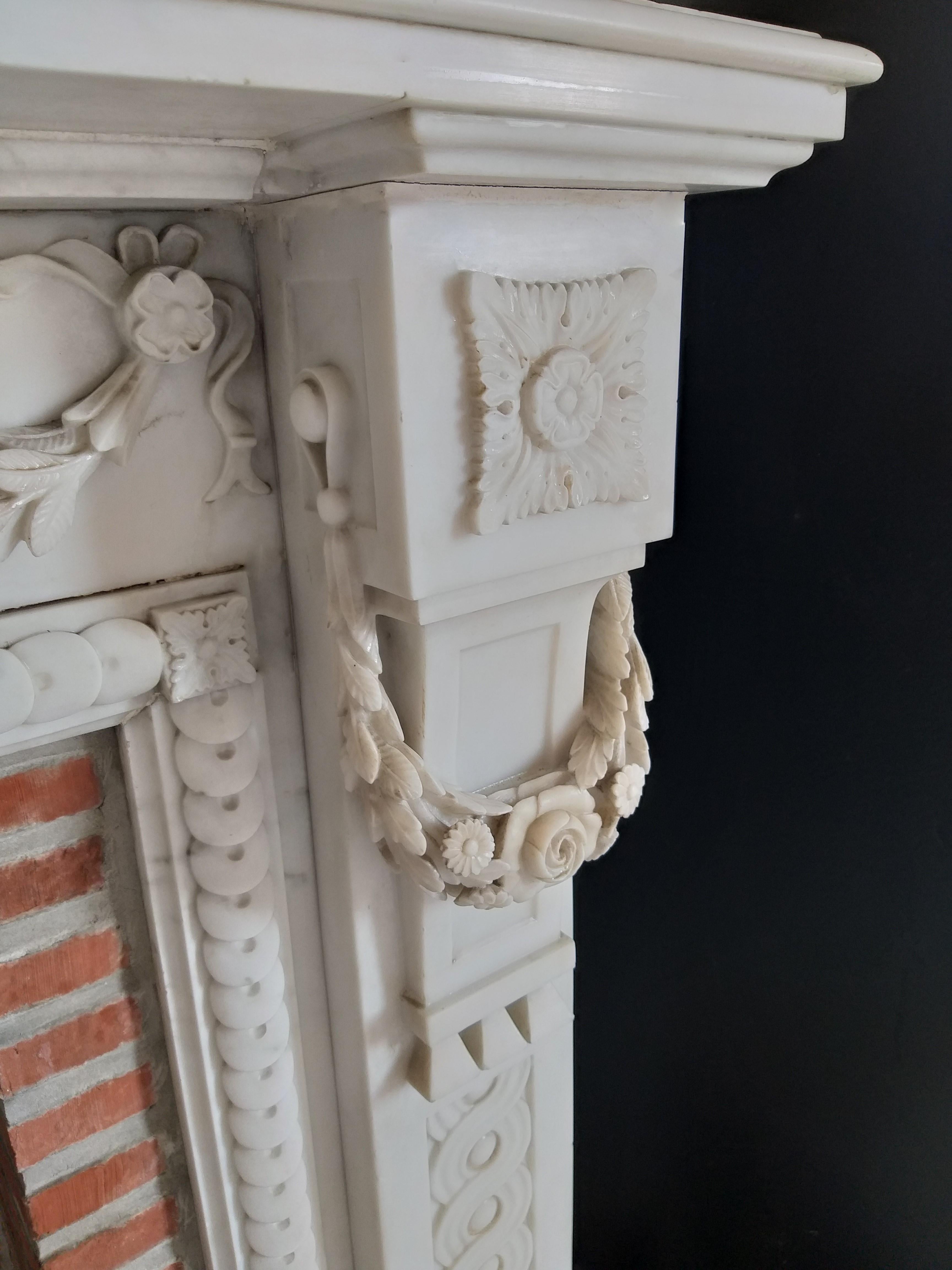 This classy, antique fireplace in Louis XVI style was made out of Carrara-marble, soft statuary, during the 19th century. It stood once in one of the rooms of the Maison Gouverneur Dubonnaire at Mons-Belgium.  Build in 1879, also the year this