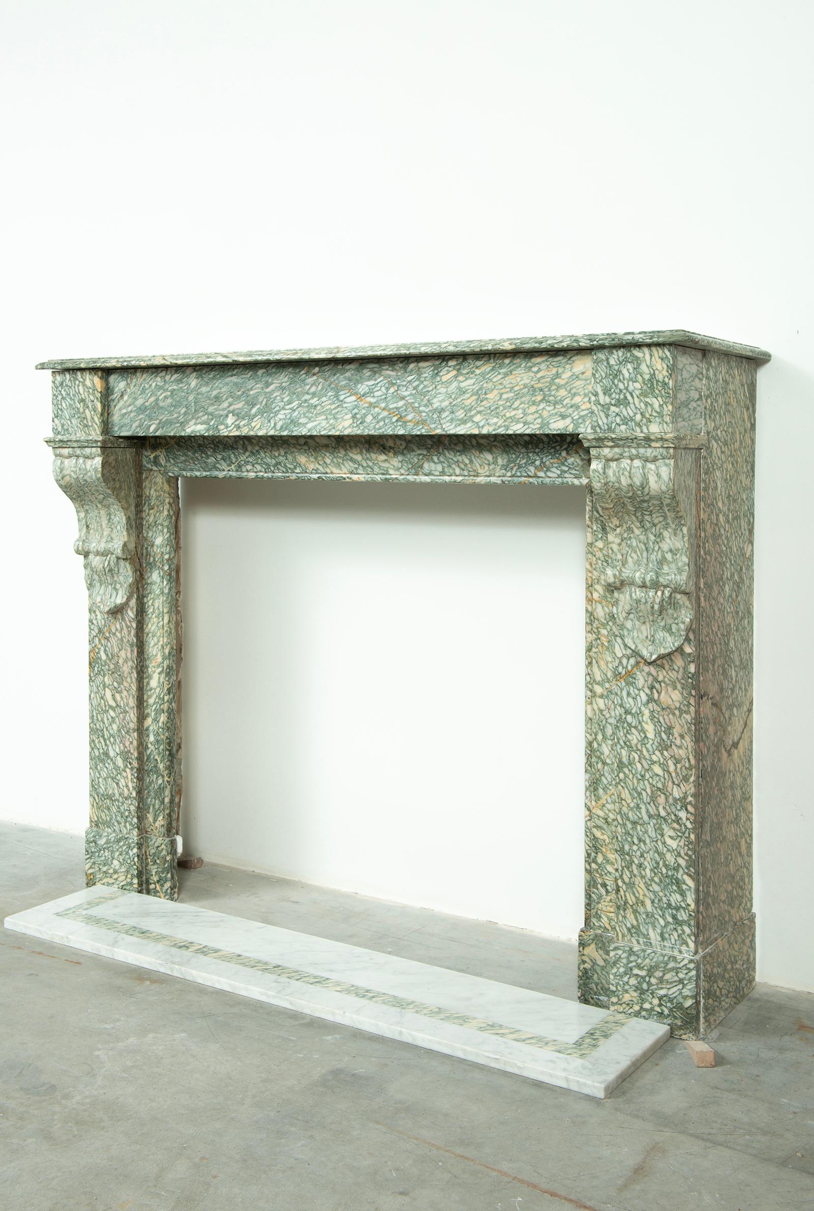 Lovely little French console fireplace in soft toned green and yellow Vert d' Estours marble.
This perfect sized mantel come with an white marble front floor with green marble inlay, beautiful piece.

This mantel is in great condition, ready to