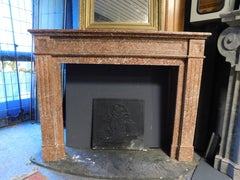Fireplace mantle carved in red "breccia pernice" marble, Italy