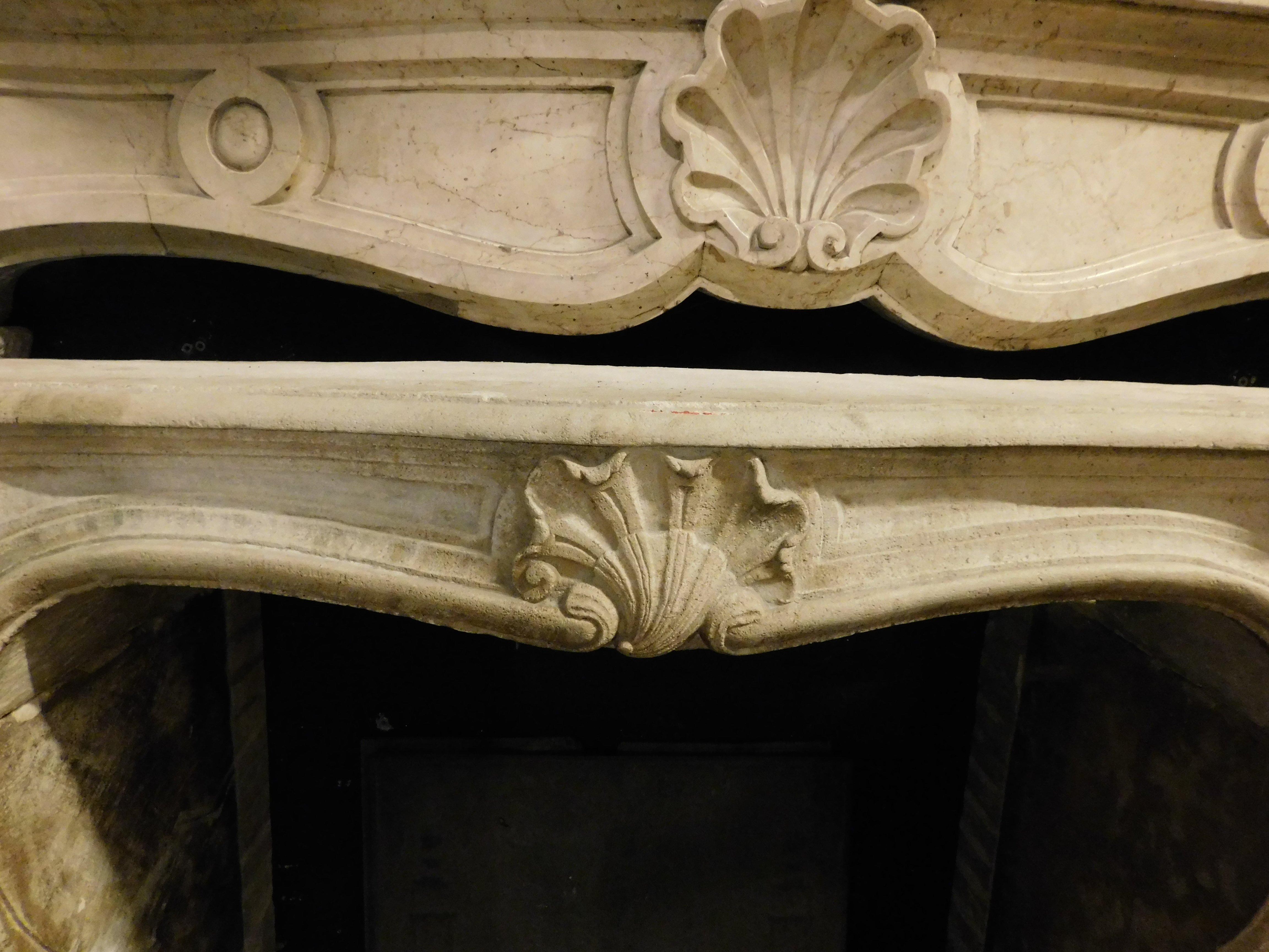 Hand-Carved Fireplace mantle in Burgundy stone with carved shell, France For Sale