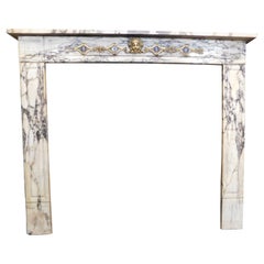 Fireplace mantle in marble, gilt brass friezes, Italy