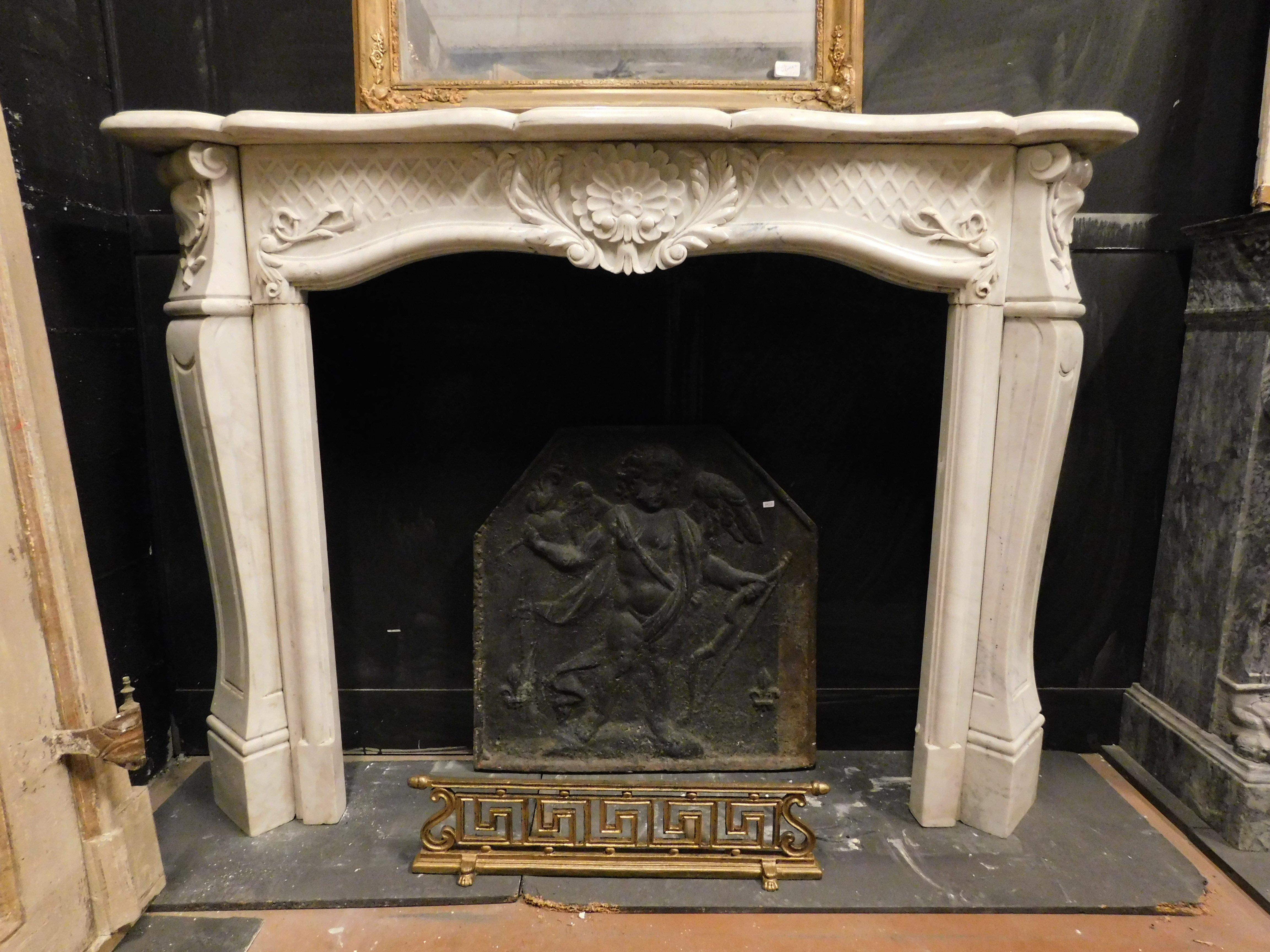 Ancient antique fireplace in white Carrara marble, richly hand-sculpted with floral and leaf decorations, built in the 19th century for a palace in Italy, maximum external measurement cm W 144 x H 110 x D 30, internal mouth measurement cm W 95 x H