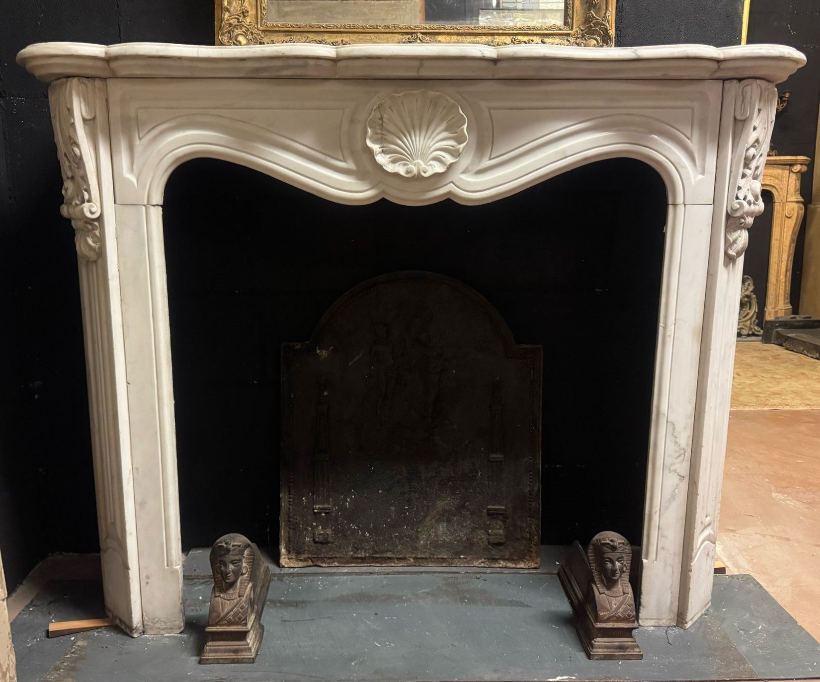 Antique Fireplace Mantle in White Carrara Marble Carved with Central Shell. The precious white Carrara marble is known throughout the world for its uniform pure white color with gray veins. Already appreciated by the ancient Romans, it has been used
