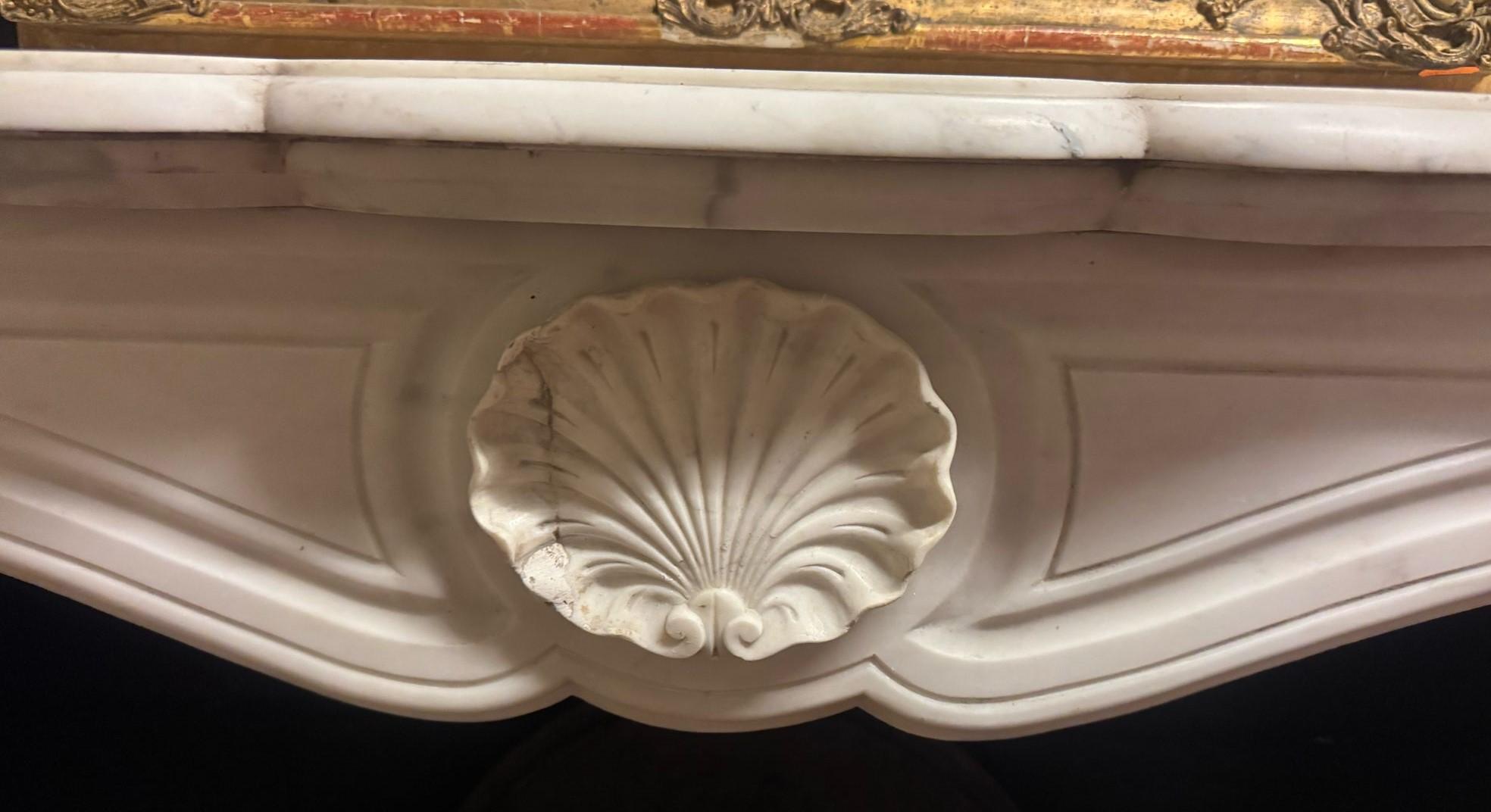 Carved Fireplace mantle in white Carrara marble carved with shell, France For Sale