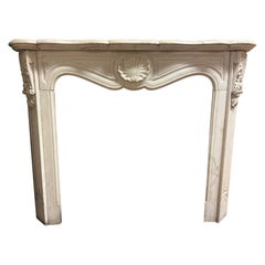 Fireplace mantle in white Carrara marble carved with shell, France