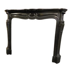 Fireplace mantle, Pompadour model carved in black marble, France