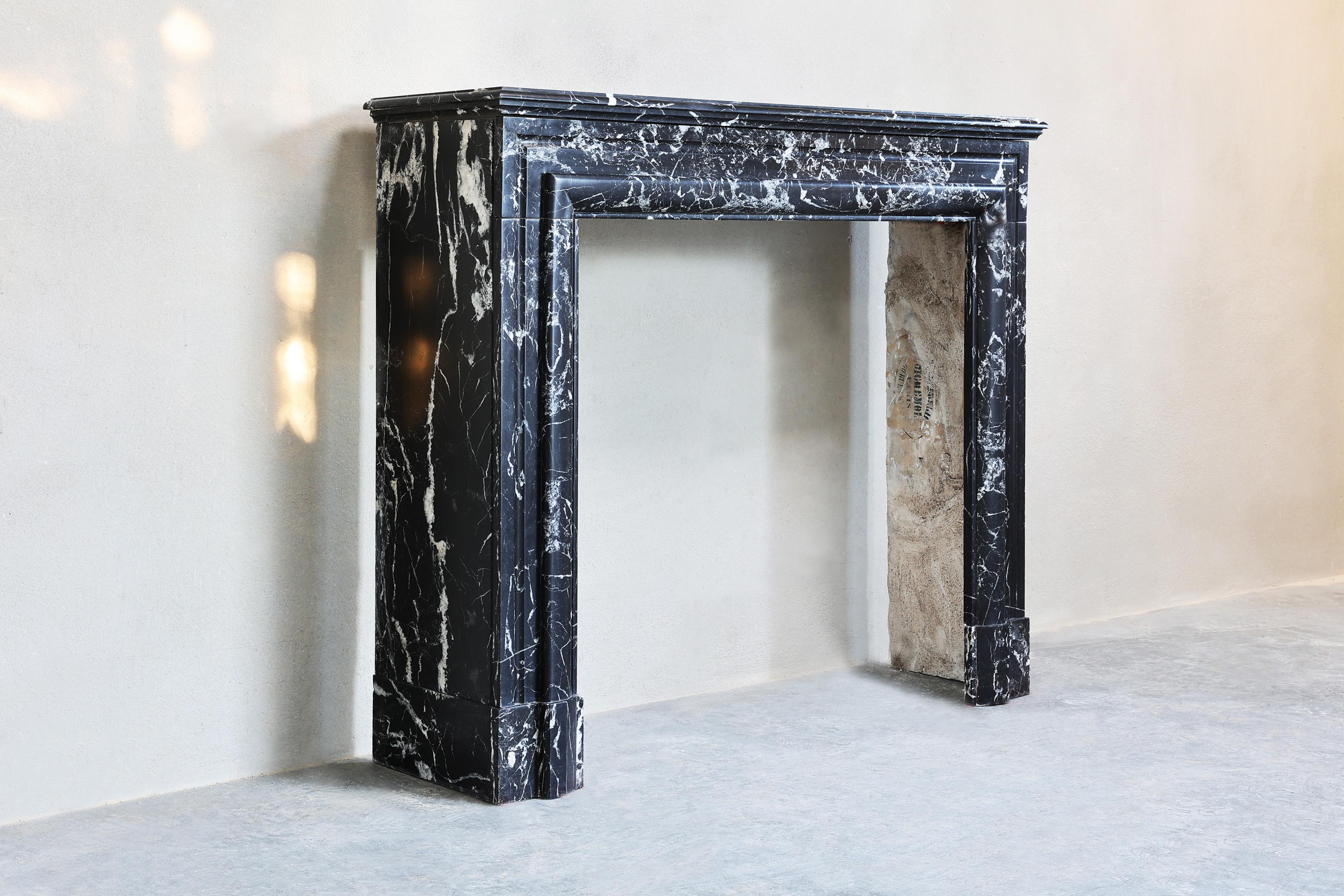 French Fireplace of black Marquina marble in style of Louis XVI from the 19th century