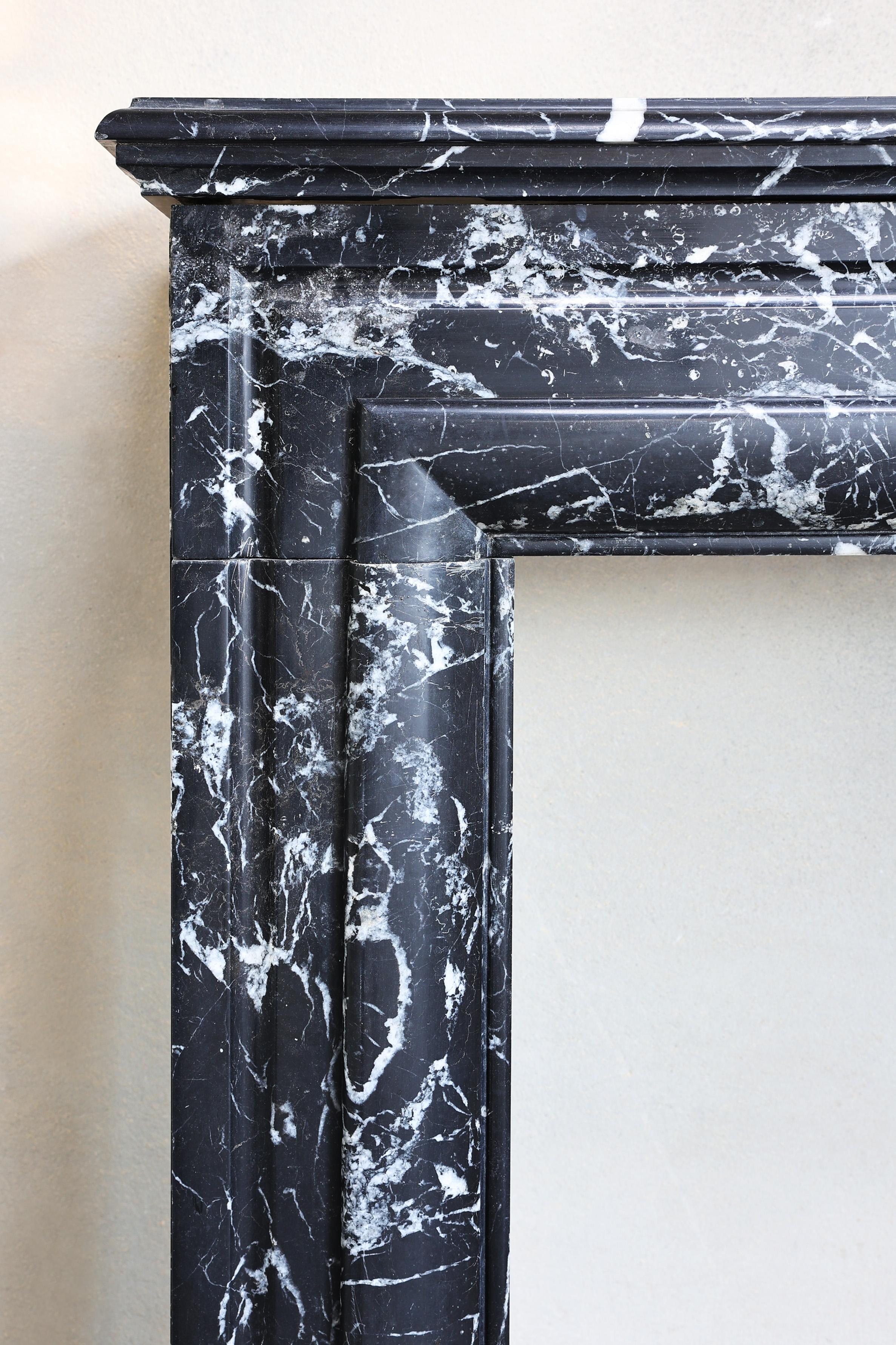 Marble Fireplace of black Marquina marble in style of Louis XVI from the 19th century