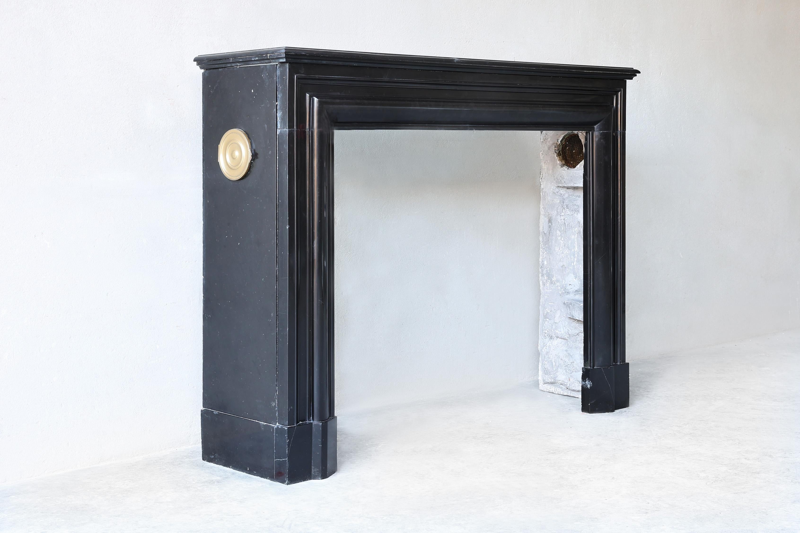Very nice antique fireplace of the 'black gold' Noir de Mazy marble. Noir de Mazy fireplaces are one of the most popular styles of fireplaces. The quarries in Belgium where this marble comes from are now closed. This fireplace is in the style of