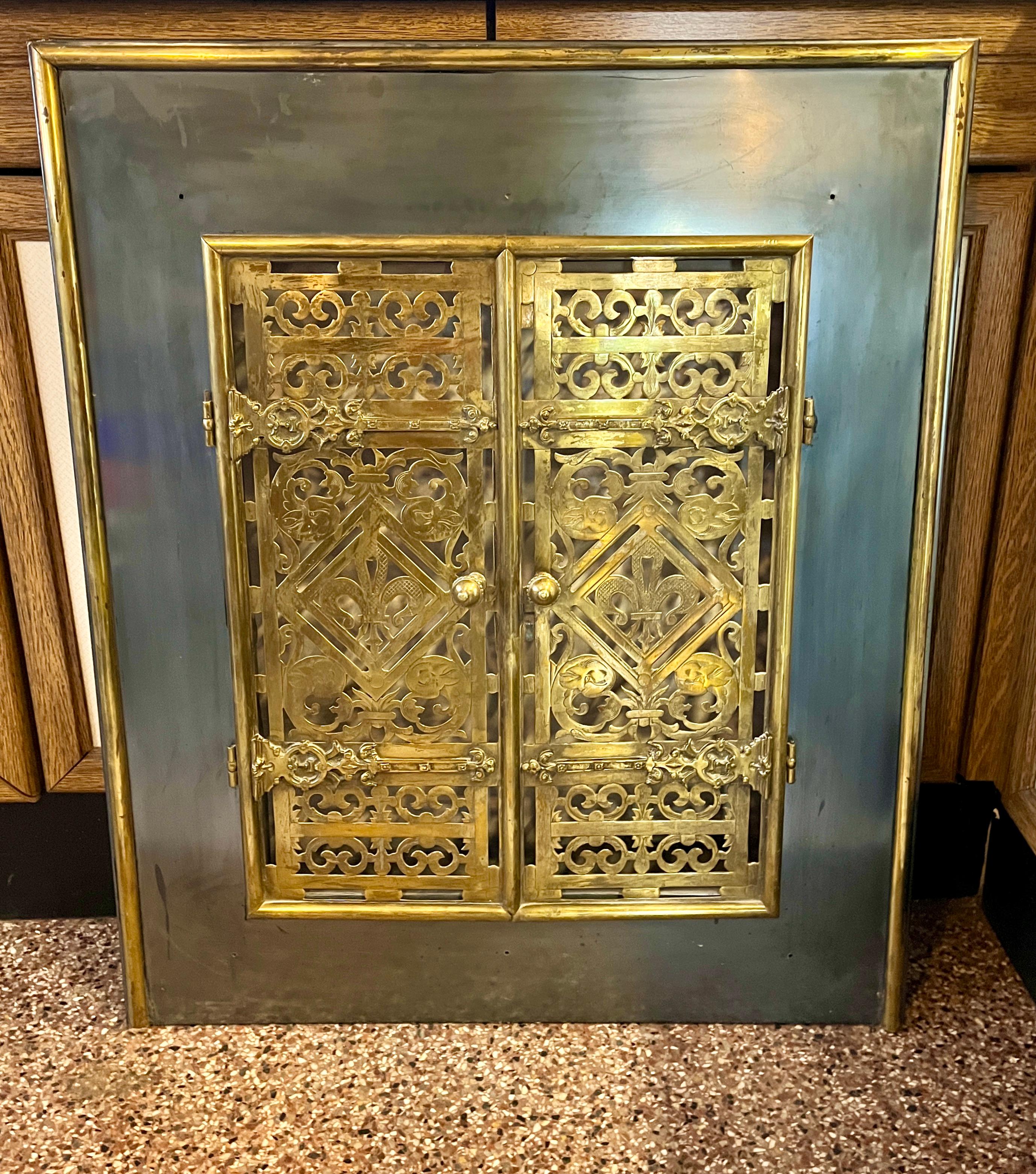  iron and brass circa 1920

 iron and brass and terminating on decorative scrolled stylized Doors

We prefer to sell our items in 'uncleaned' condition so that the new owner 
still has the choice to remove the patina (signs of age) or