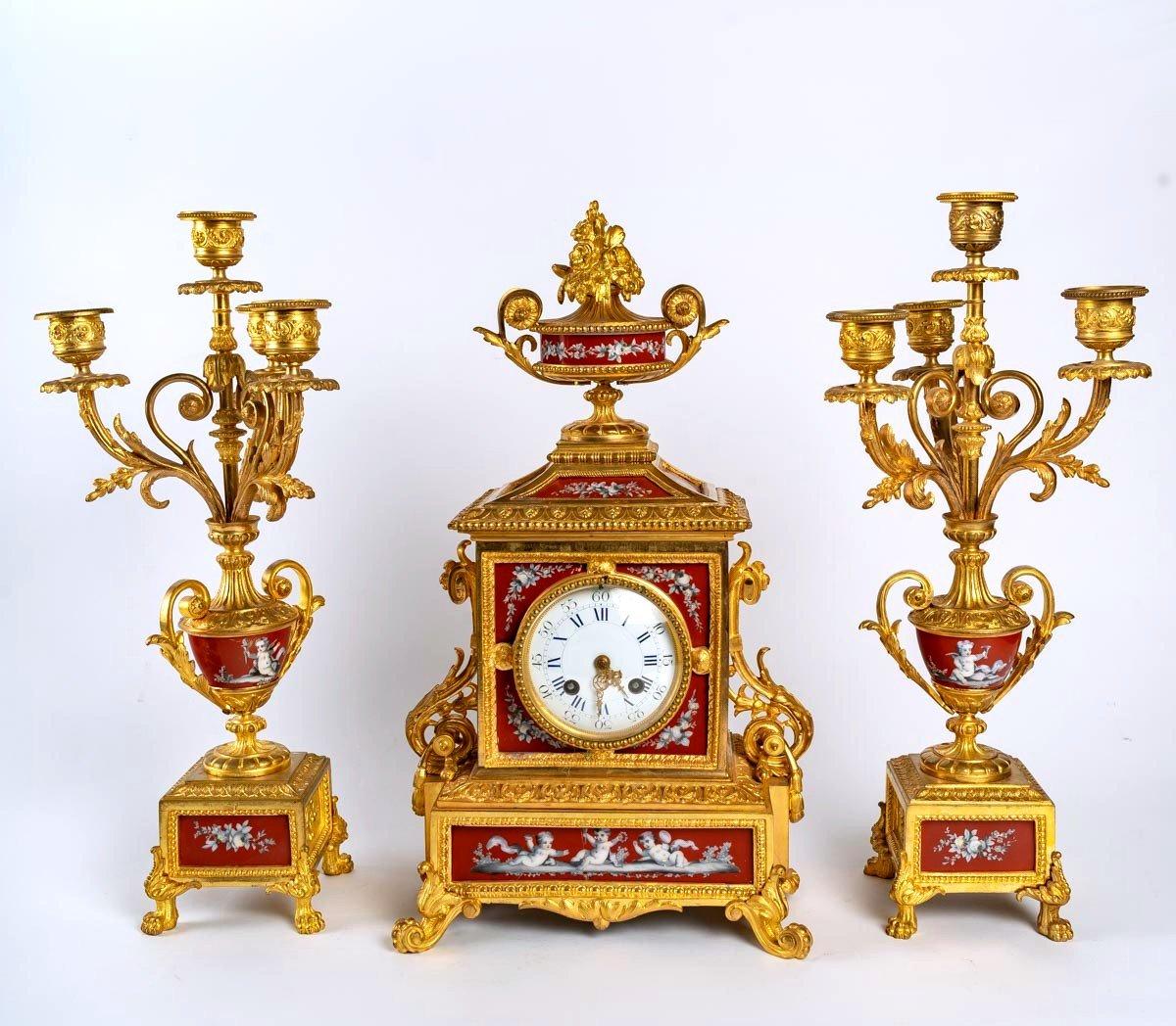 Fireplace set, Napoleon III period
Bronze mantelpiece and enamelled porcelain plate, Napoleon III period
Measures: Clock - H: 43 cm, W: 24 cm, D: 16 cm
Candlestick - H: 42 cm, W: 20 cm, D: 17 cm.
   