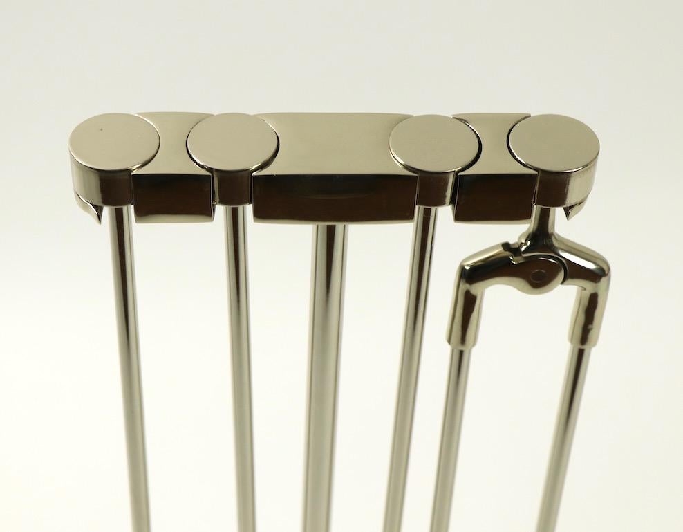 Exquisite design and craftsmanship, excellent original condition, chic and sophisticated fireplace tool set. This set was designed by Nancy Ruben for Virginia. Top quality set, in original finish, which reads slightly yellow gold in color clean and