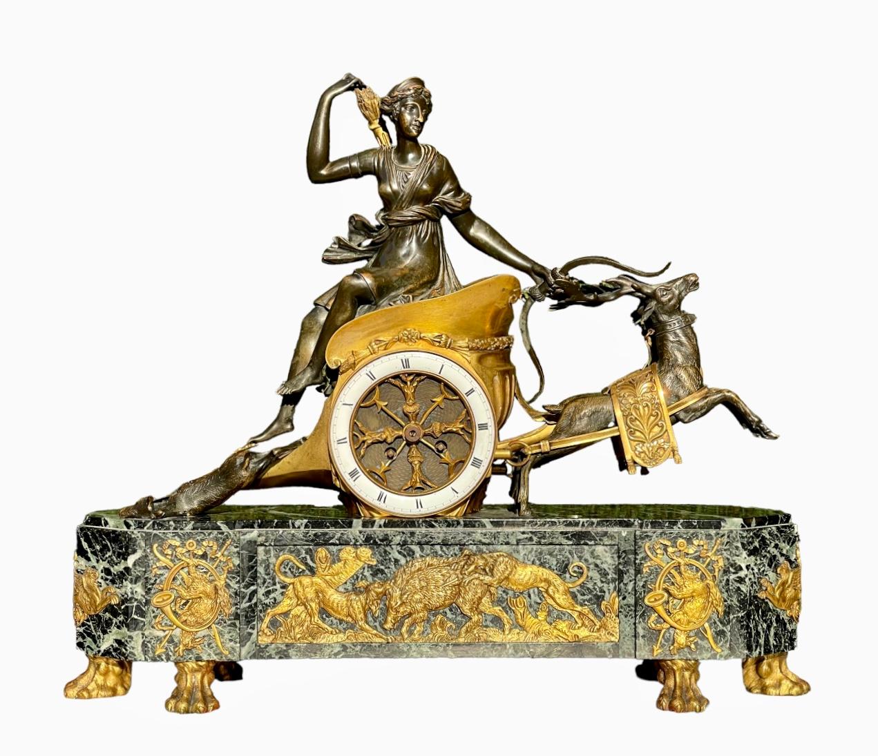 Superb Napoleon III period fireplace trim. It consists of an imposing clock in gilded and patinated bronze with a sea green marble base representing the goddess of the hunt, Diana the Huntress. She is standing on a chariot pulled by two deer. The
