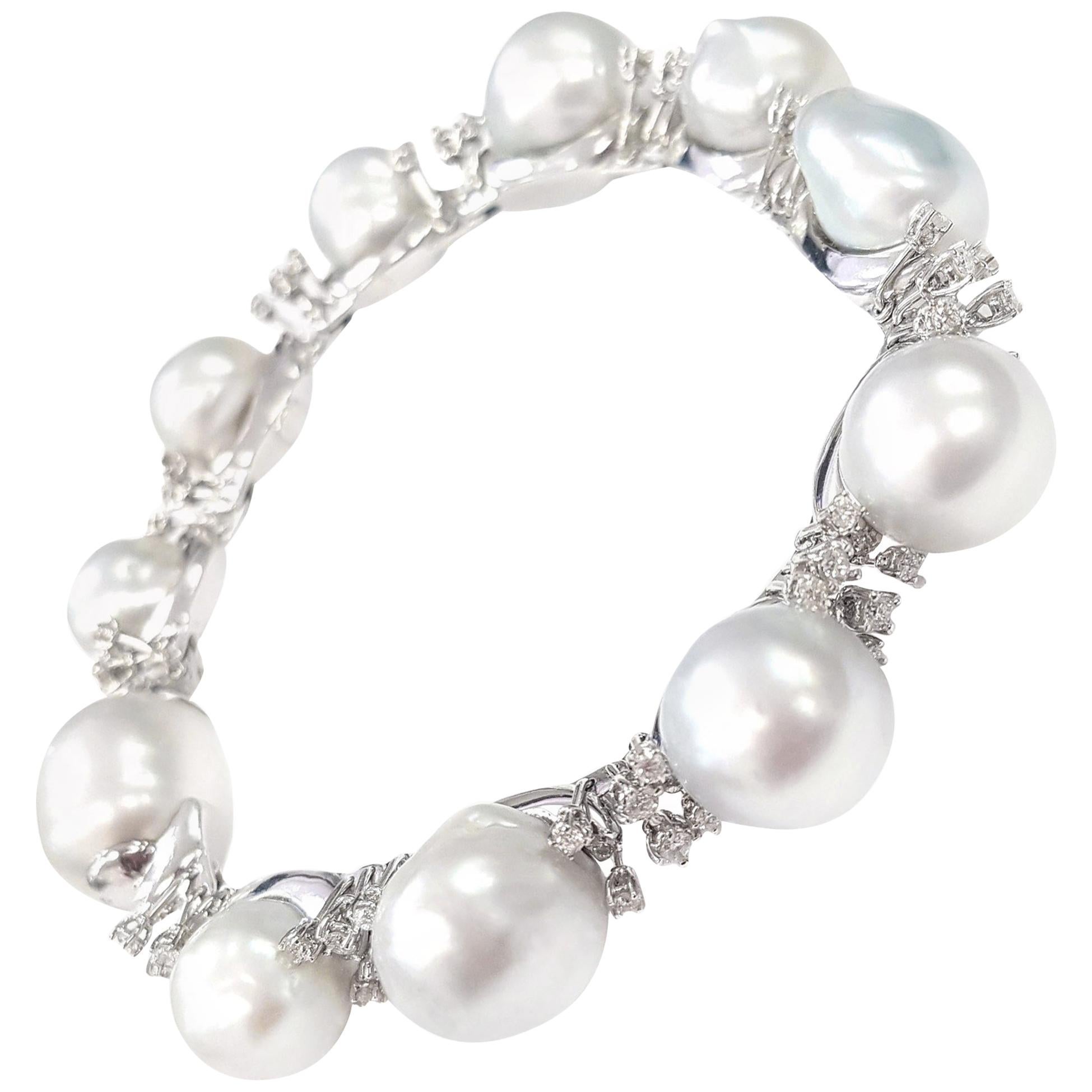 A gorgeous bracelet of large scaramazza pearls set in 18-karat white gold that alternate with clusters of sparkly white diamonds (1.86 carats total diamonds) that appear to burst from the setting like a miniature firework display. 

The setting for
